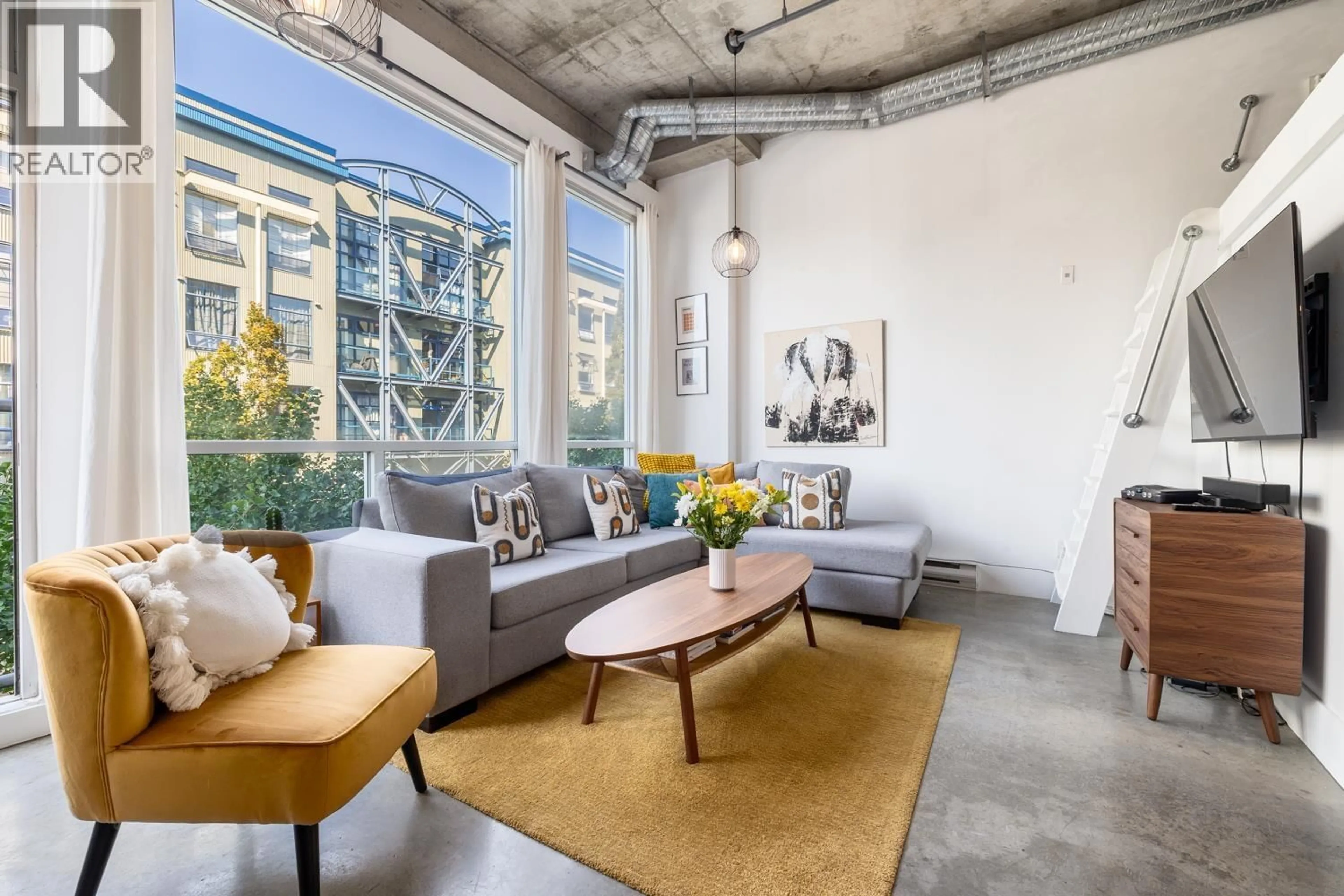 Living room with furniture, cement floor for 204 - 228 4 AVENUE, Vancouver British Columbia V5T1G5