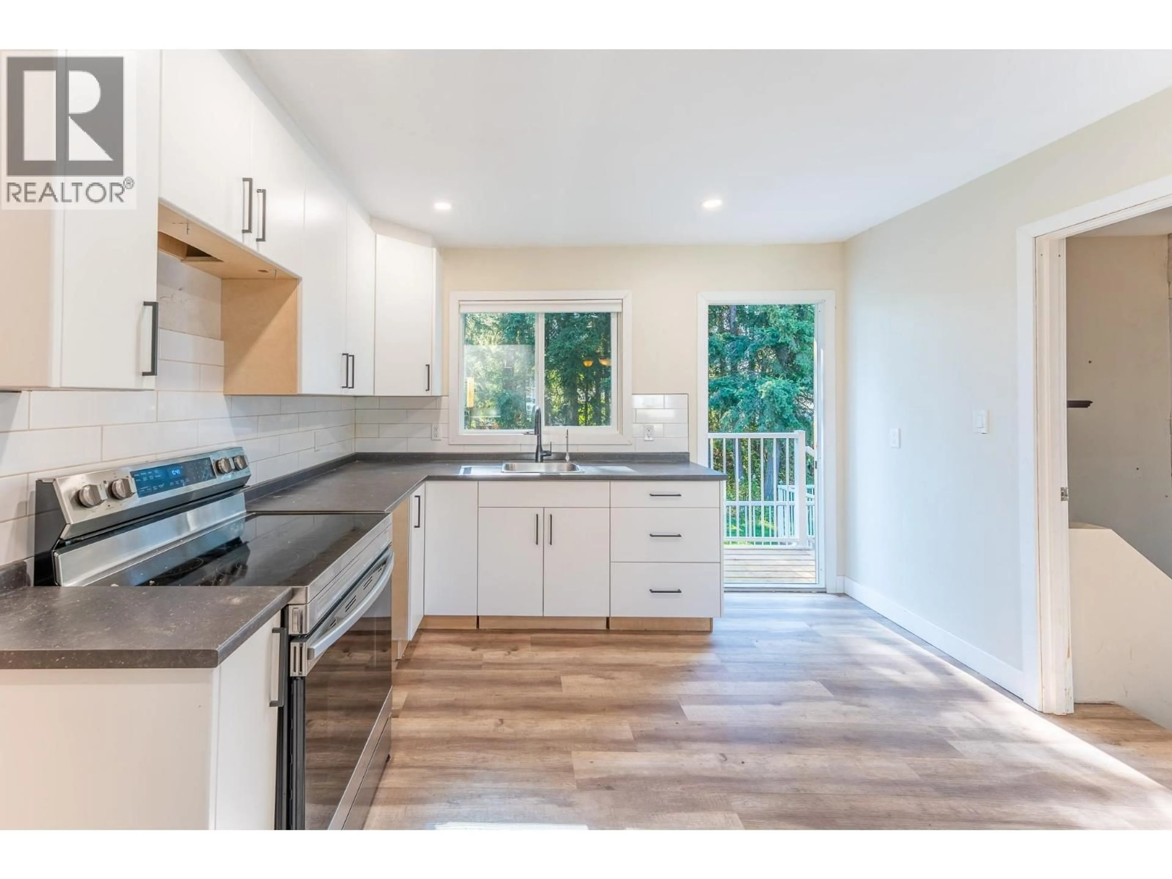 Open concept kitchen, wood/laminate floor for 2886 LANGLEY CRESCENT, Prince George British Columbia V2K3J8