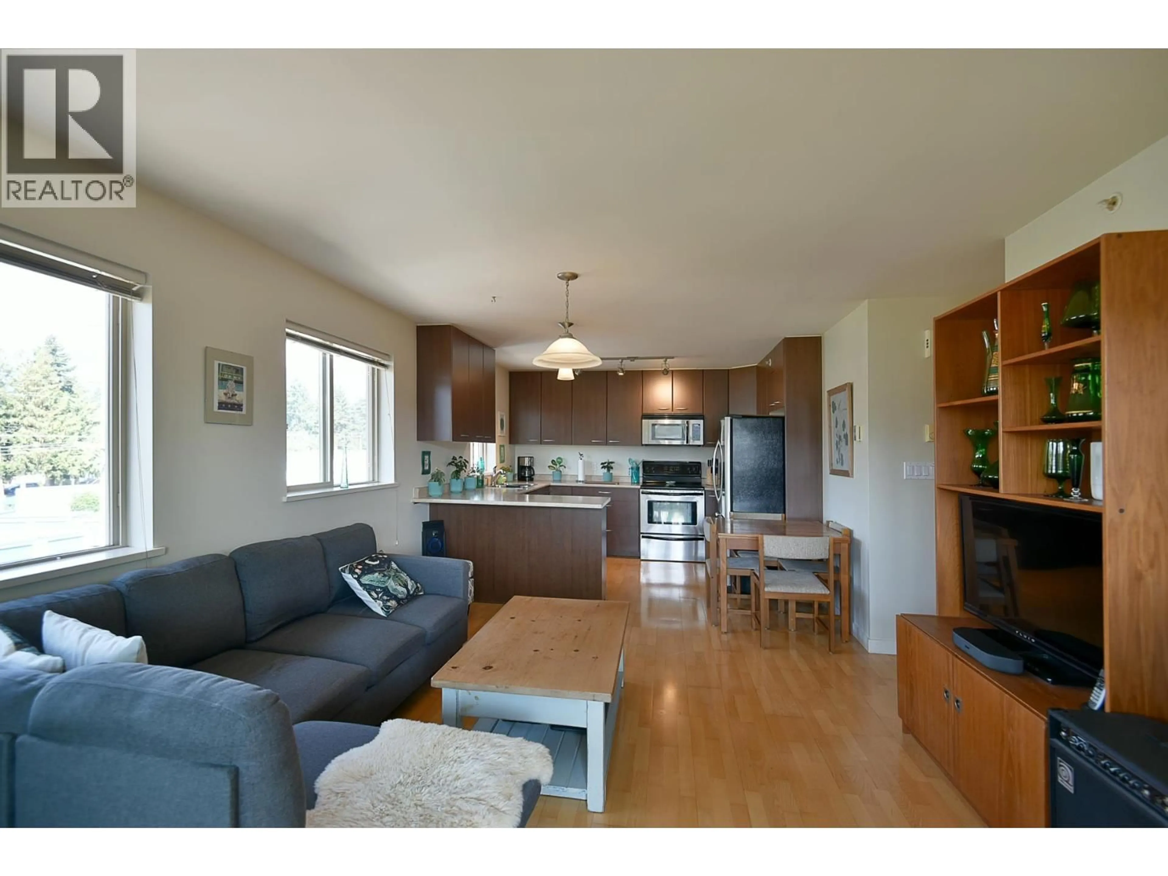 Open concept kitchen, wood/laminate floor for 408 - 5631 INLET AVENUE, Sechelt British Columbia V7Z0J1