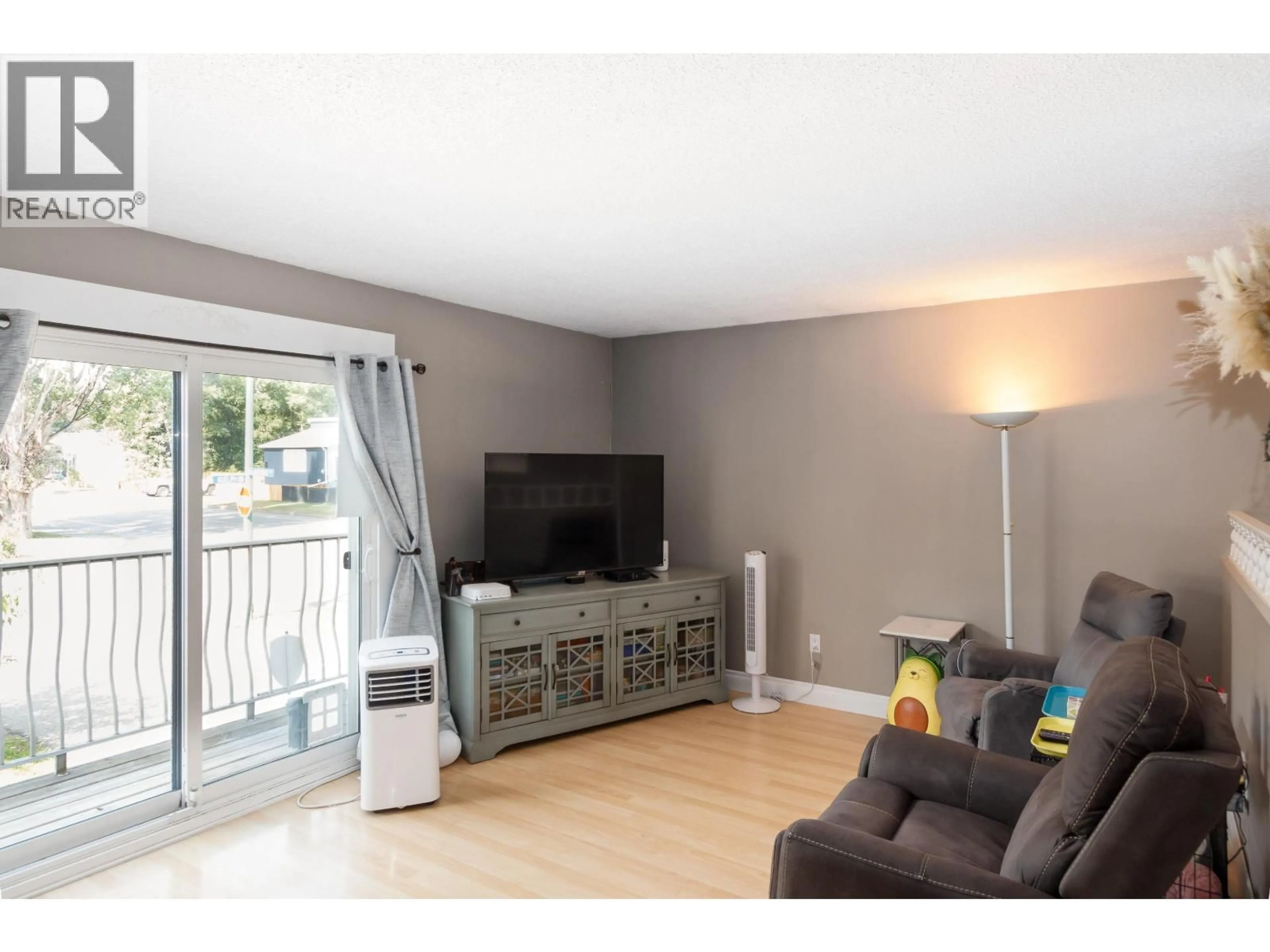 Living room with furniture, wood/laminate floor for 7010 GUELPH CRESCENT, Prince George British Columbia V2N3P1
