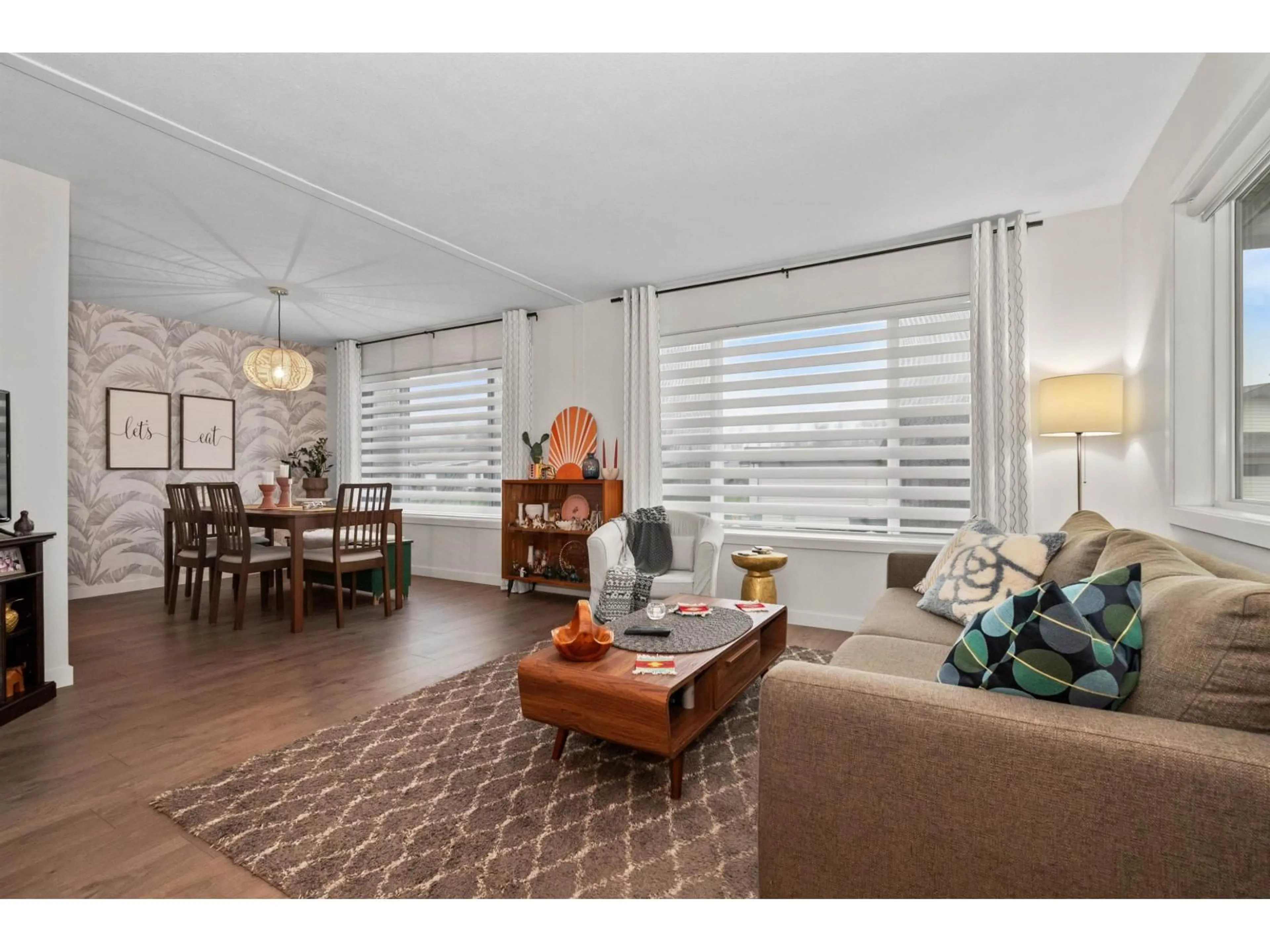 Living room with furniture, wood/laminate floor for 101 - 9055 ASHWELL ROAD, Chilliwack British Columbia V2P7S6
