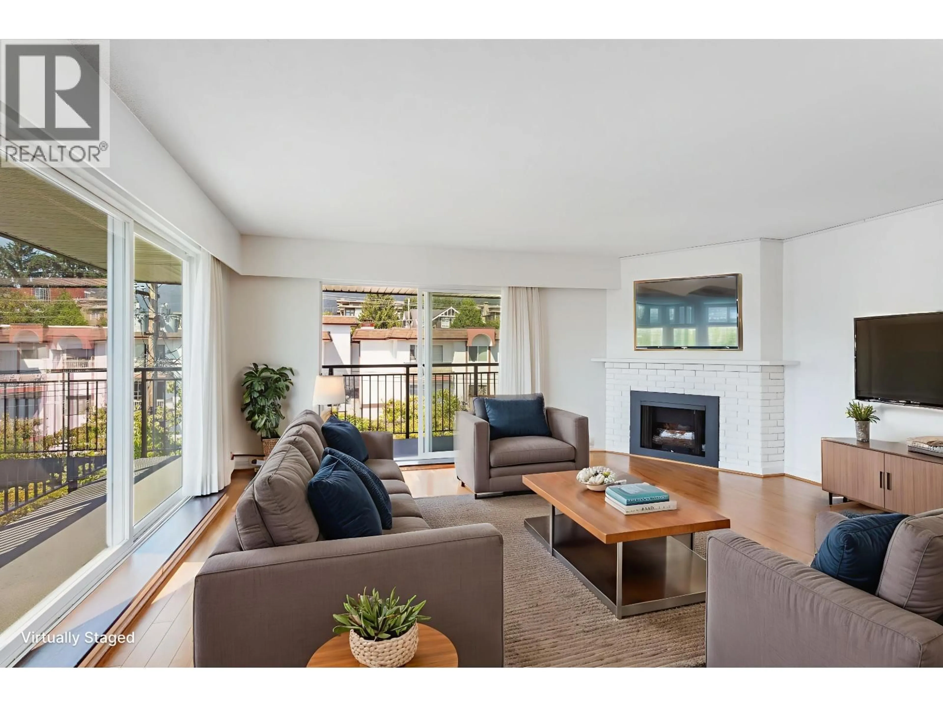 Living room with furniture, wood/laminate floor for 303 - 134 20TH STREET, North Vancouver British Columbia V7M1Y4