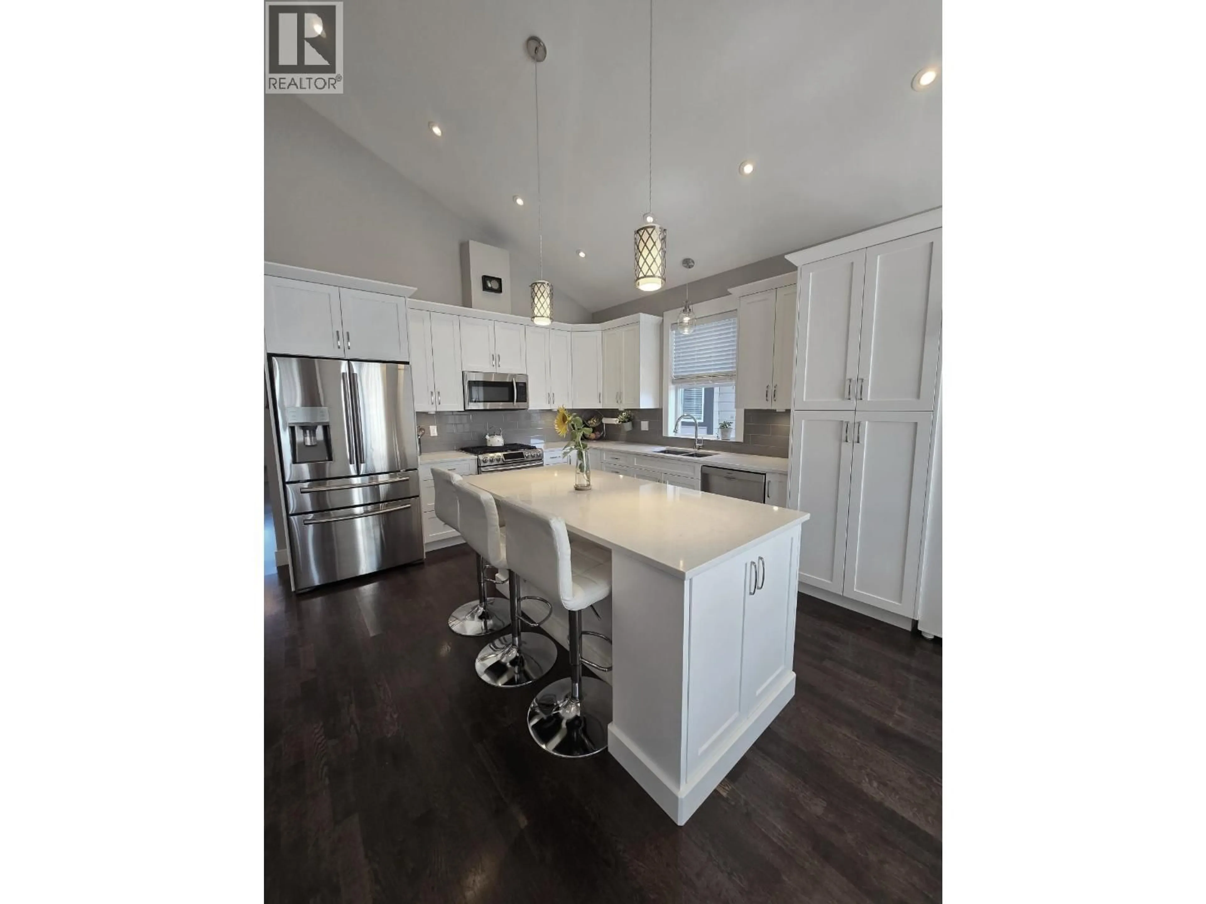 Open concept kitchen, wood/laminate floor for 11203 115 AVENUE, Fort St. John British Columbia V1J0N4