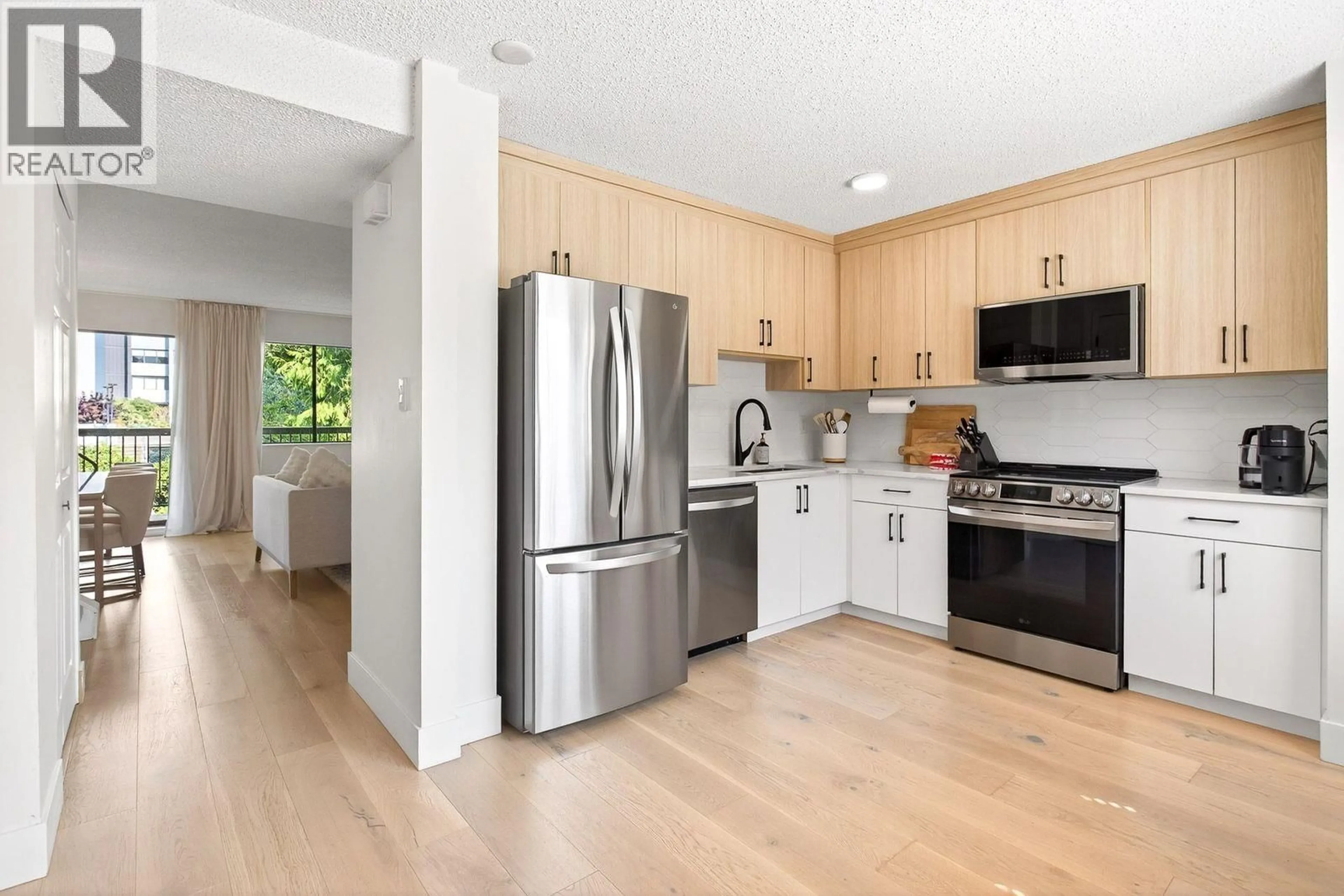 Open concept kitchen, wood/laminate floor for 7301 CAPISTRANO DRIVE, Burnaby British Columbia V5A1P7