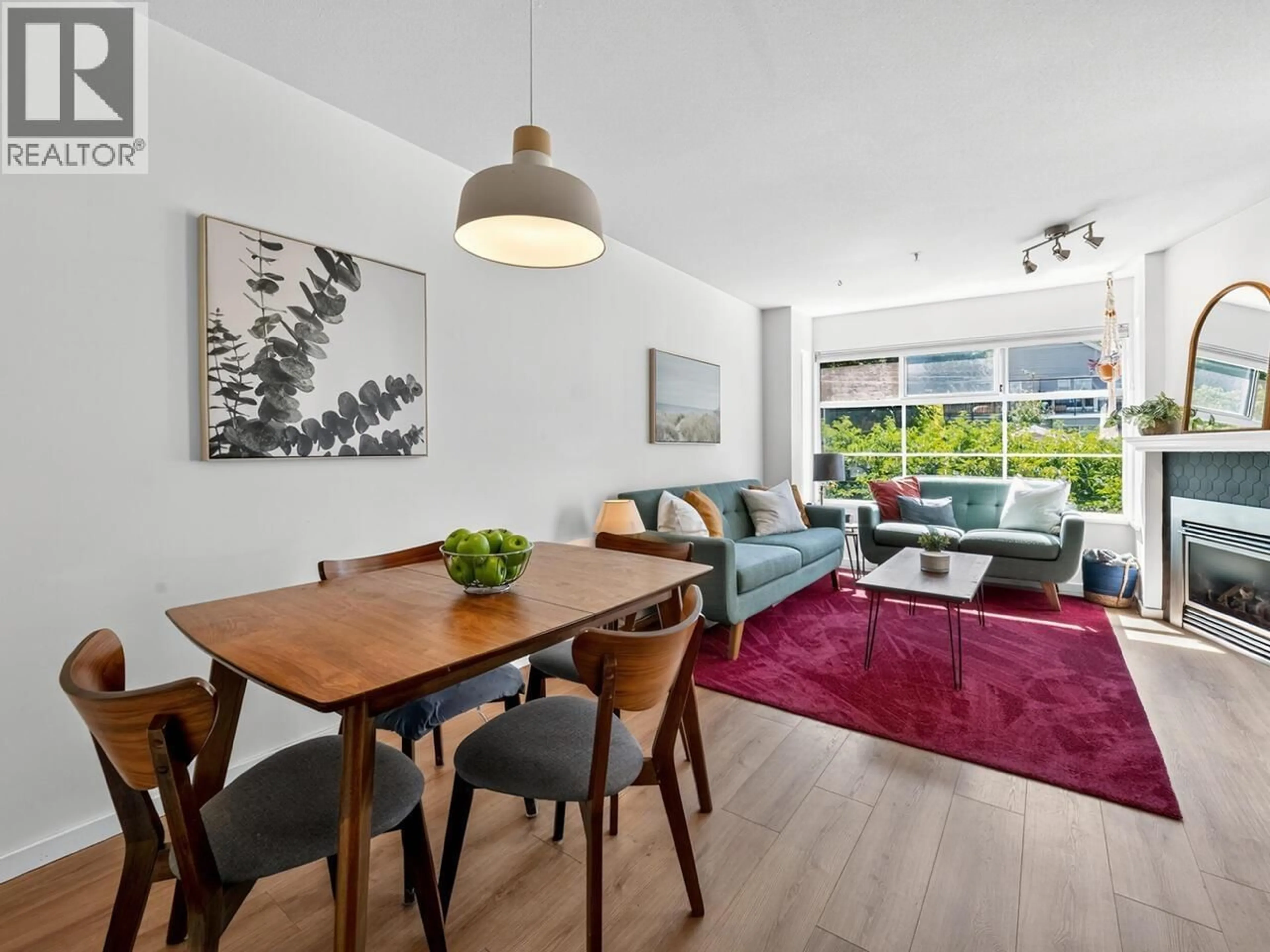 Living room with furniture, wood/laminate floor for 302 - 2388 TRIUMPH STREET, Vancouver British Columbia V5L1L5