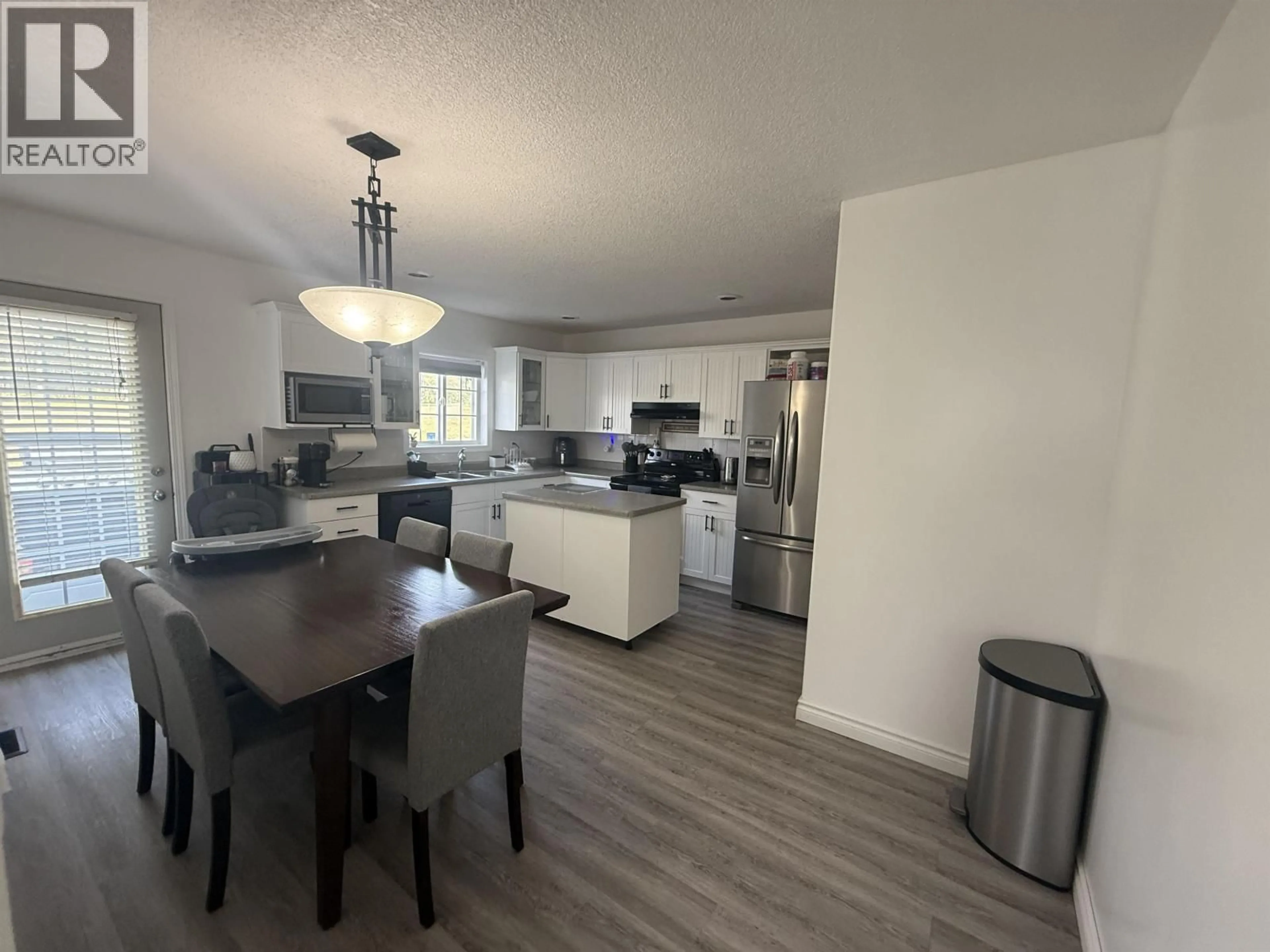 Open concept kitchen, wood/laminate floor for 9223 89 STREET, Fort St. John British Columbia V1J4Z3