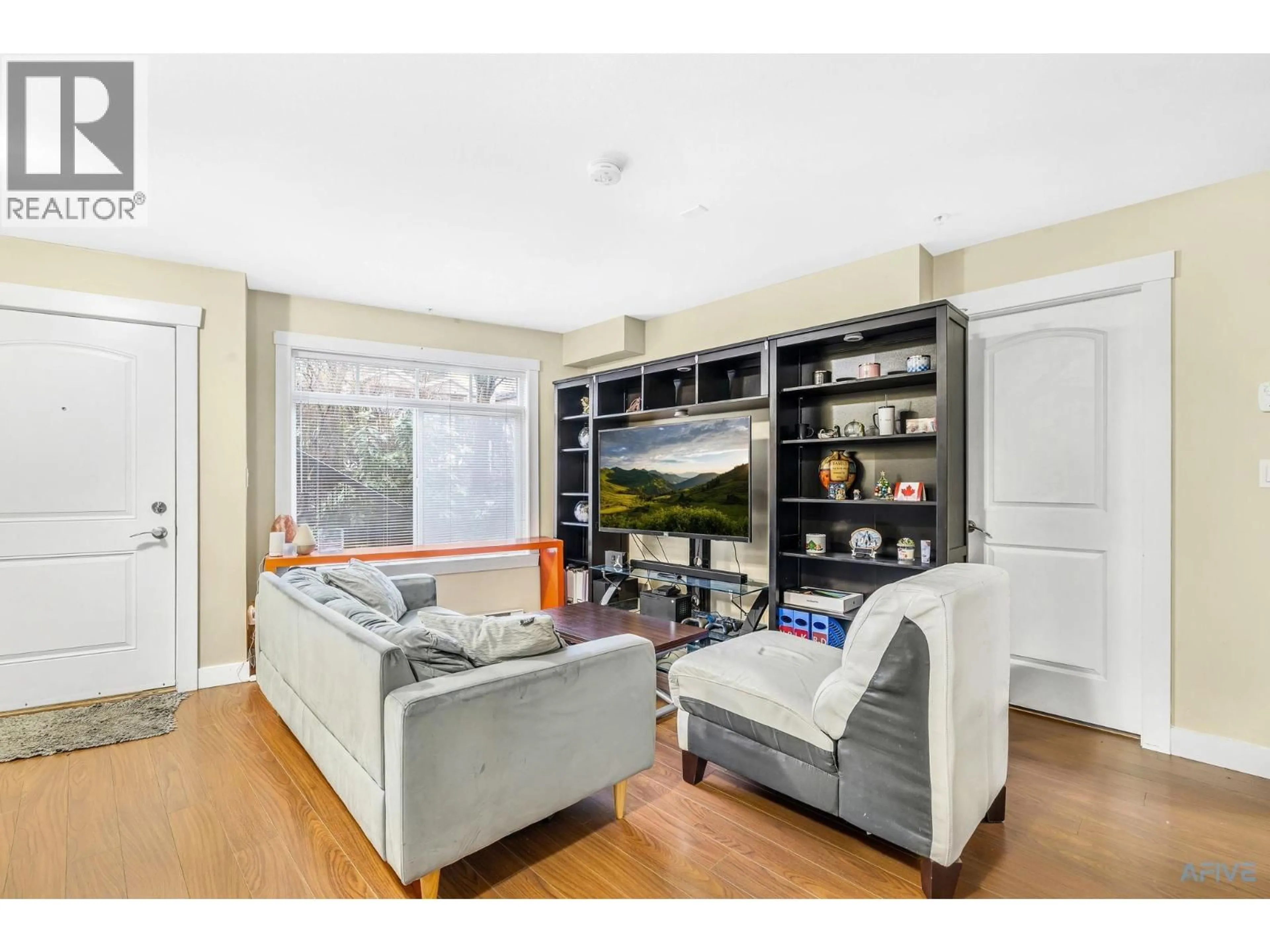 Living room with furniture, wood/laminate floor for 11 - 7428 14TH AVENUE, Burnaby British Columbia V3N0C2