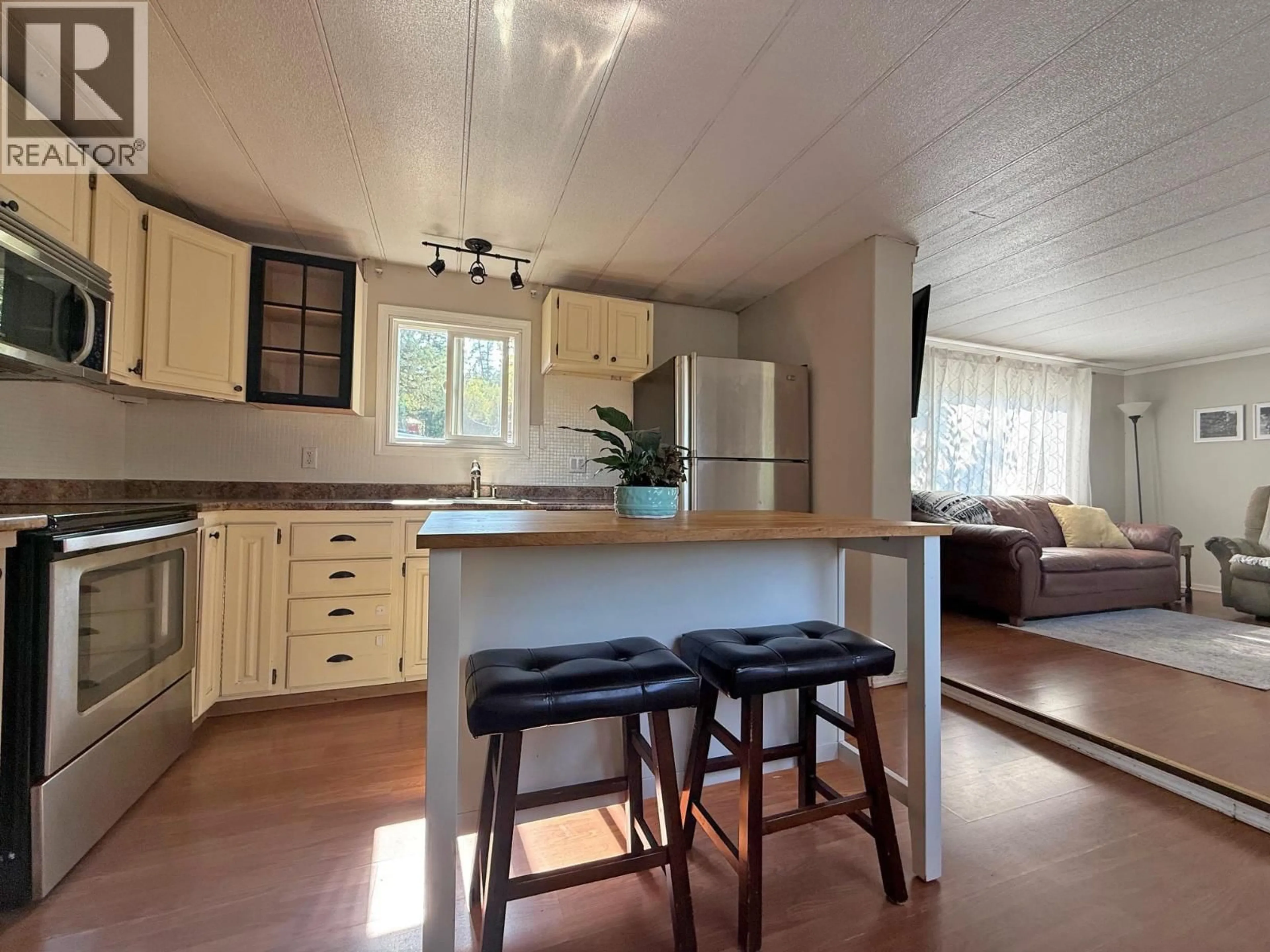 Open concept kitchen, wood/laminate floor for 542 HODGSON ROAD, Williams Lake British Columbia V2G3P9