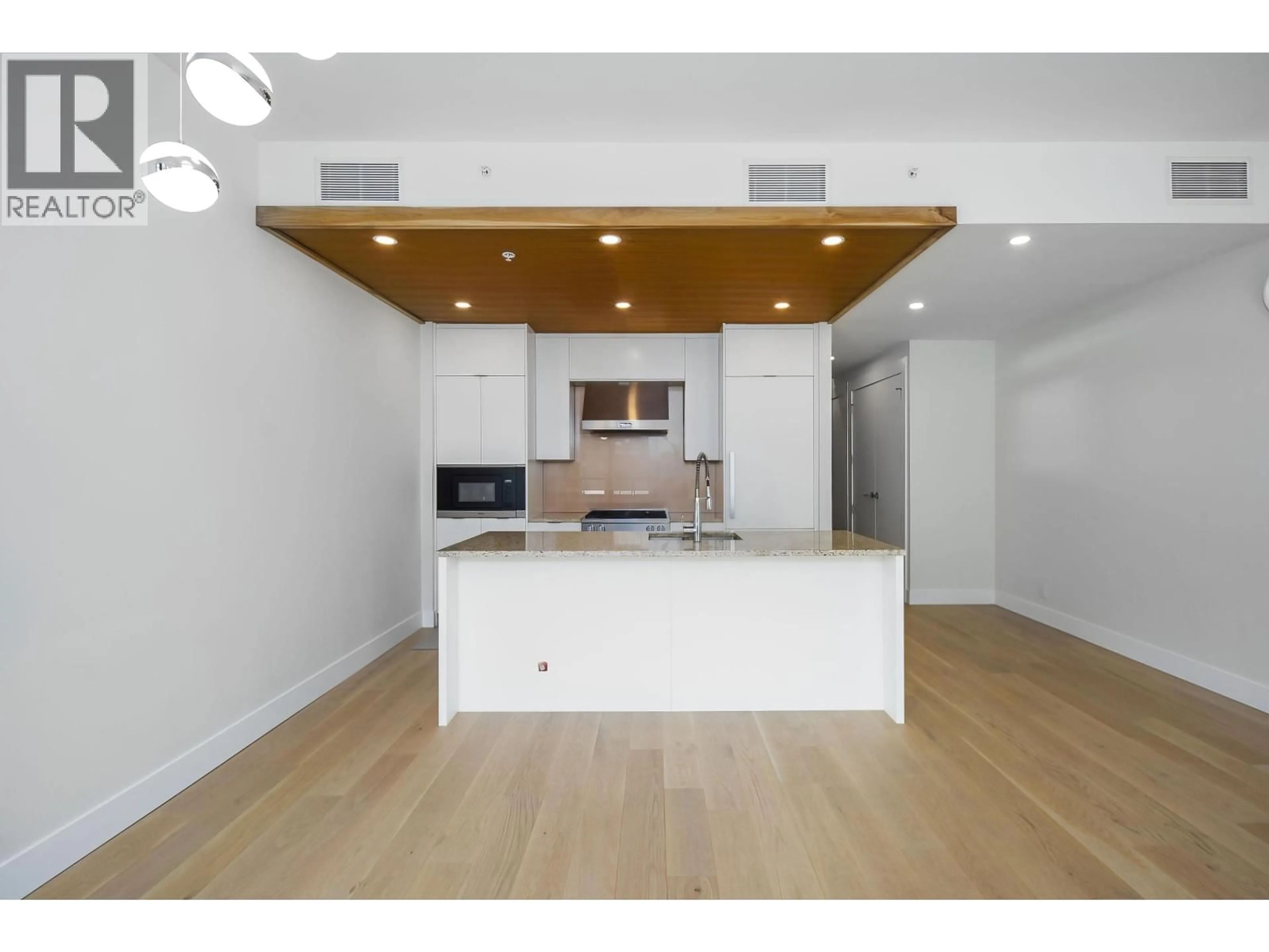 Open concept kitchen, wood/laminate floor for 406 - 6687 NELSON AVENUE, Vancouver British Columbia V7W2B2