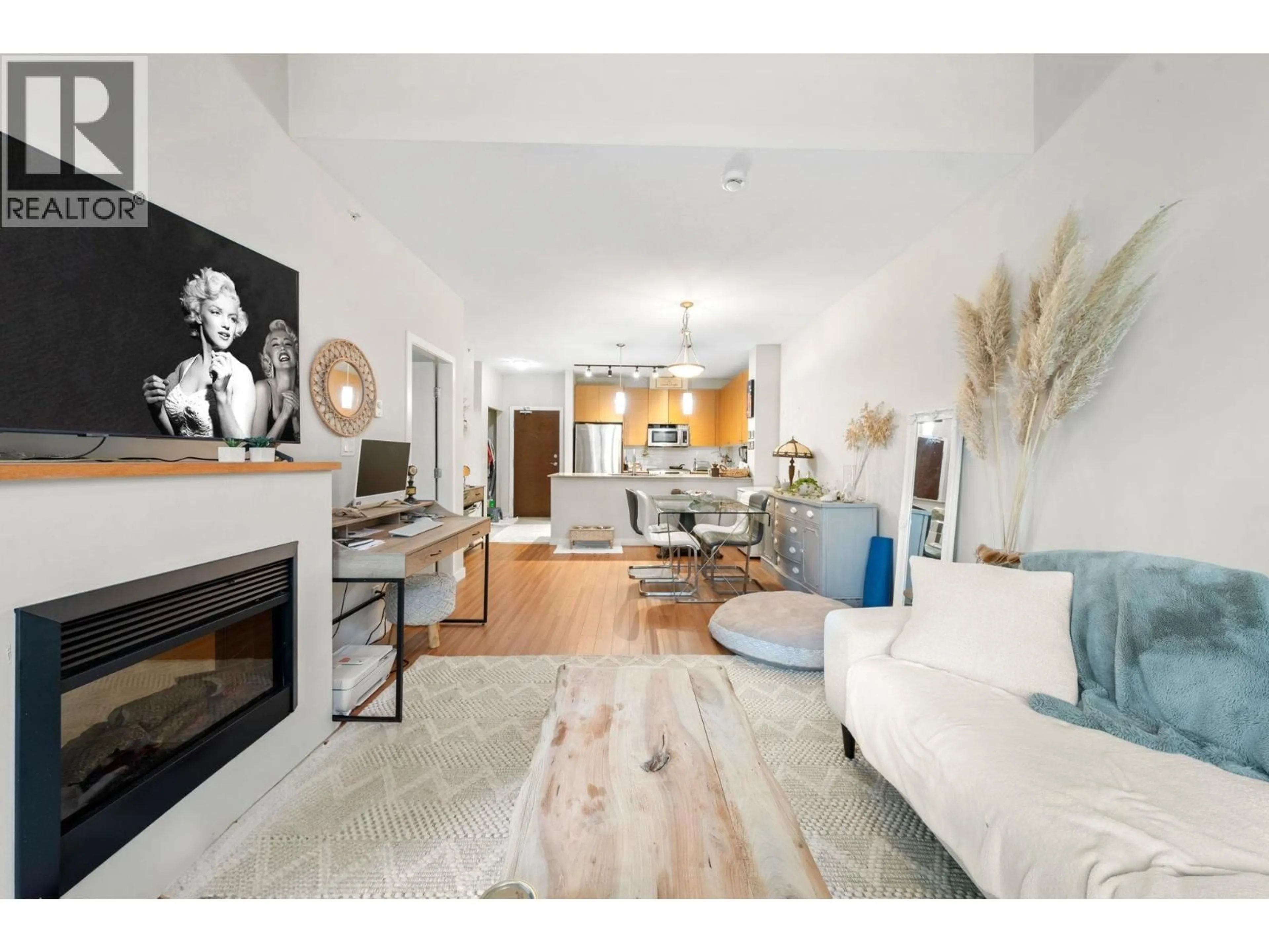 Living room with furniture, wood/laminate floor for 411 - 201 MORRISSEY ROAD, Port Moody British Columbia V3H0E5