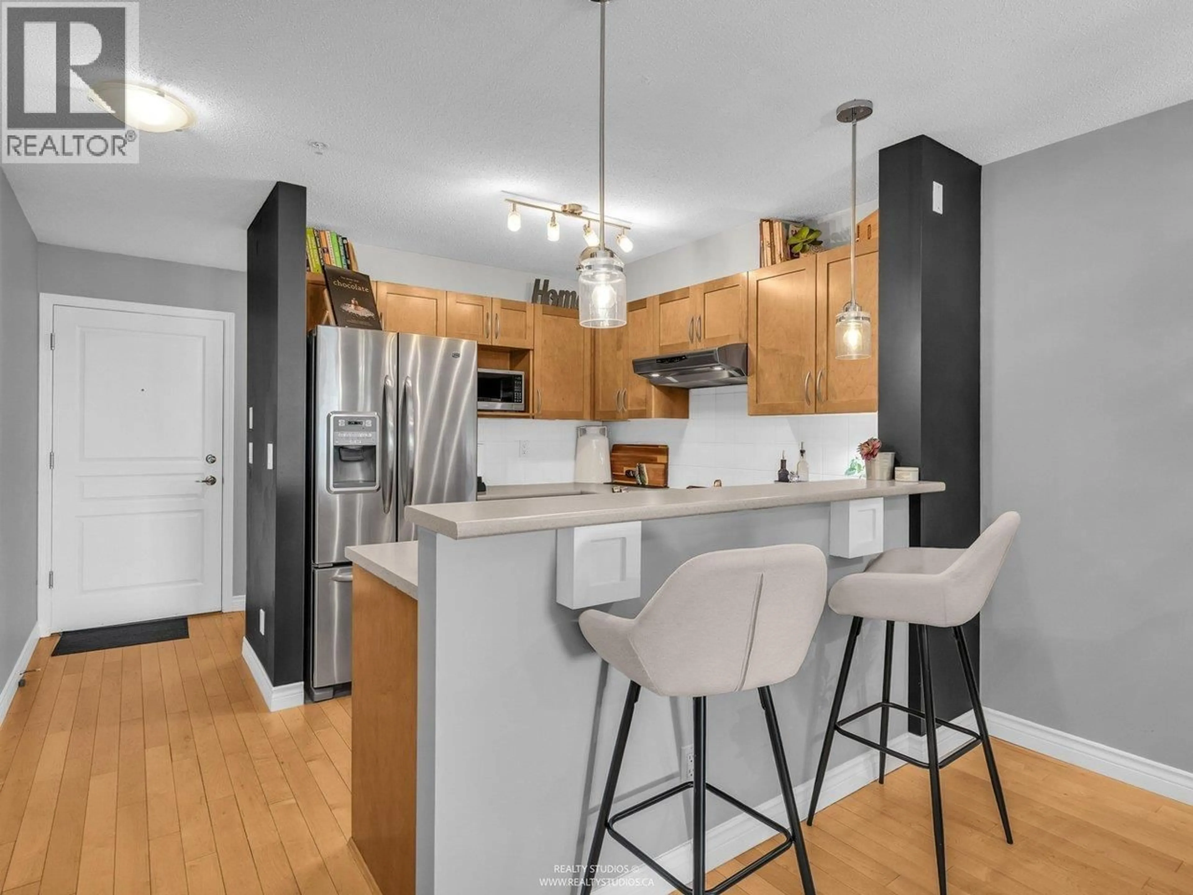 Open concept kitchen, wood/laminate floor for 105 - 333 1ST STREET, North Vancouver British Columbia V7L4W9