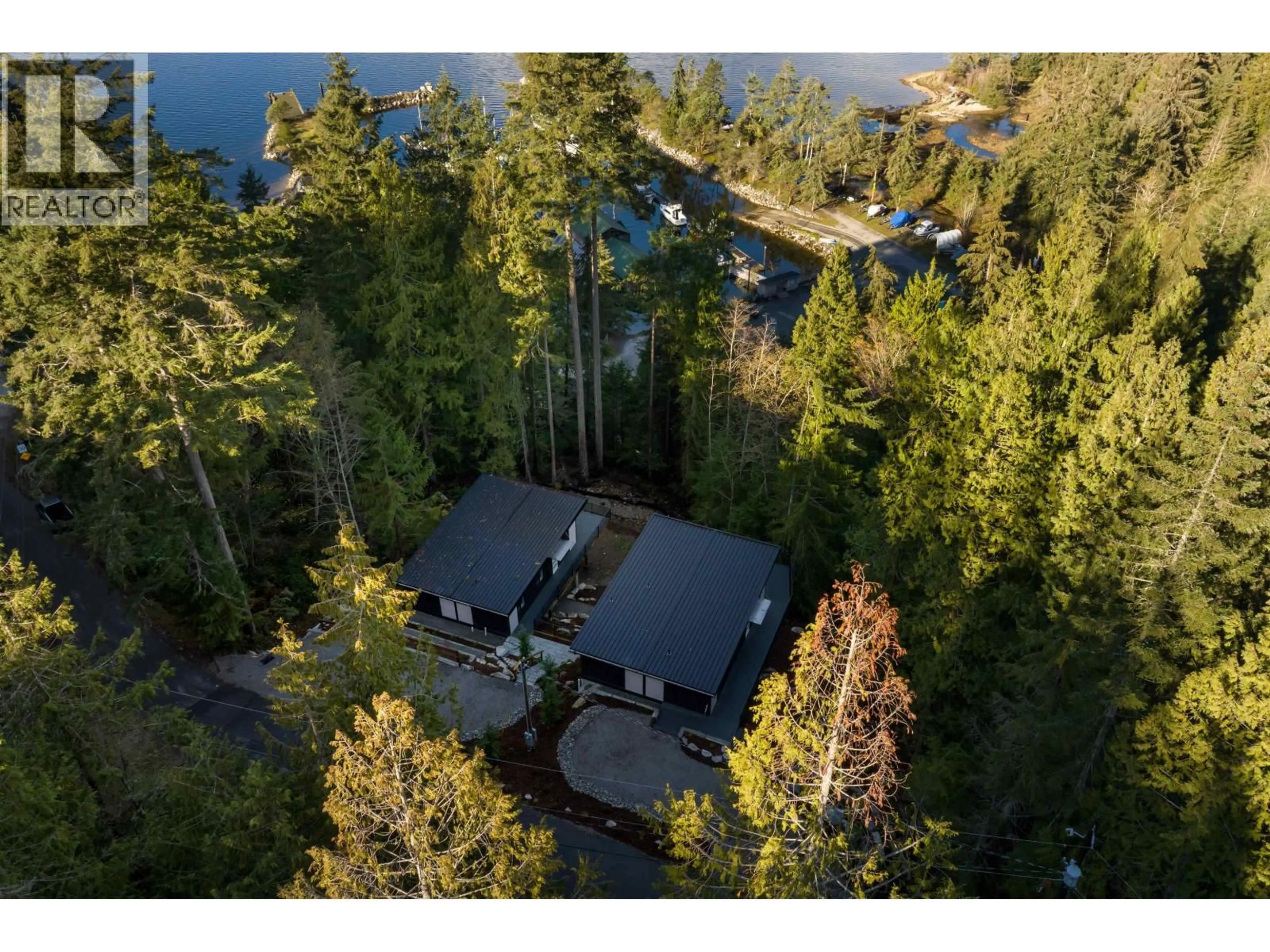 A pic from outside/outdoor area/front of a property/back of a property/a pic from drone, water/lake/river/ocean view for 5790 TILLICUM BAY ROAD, Sechelt British Columbia V7Z0C7