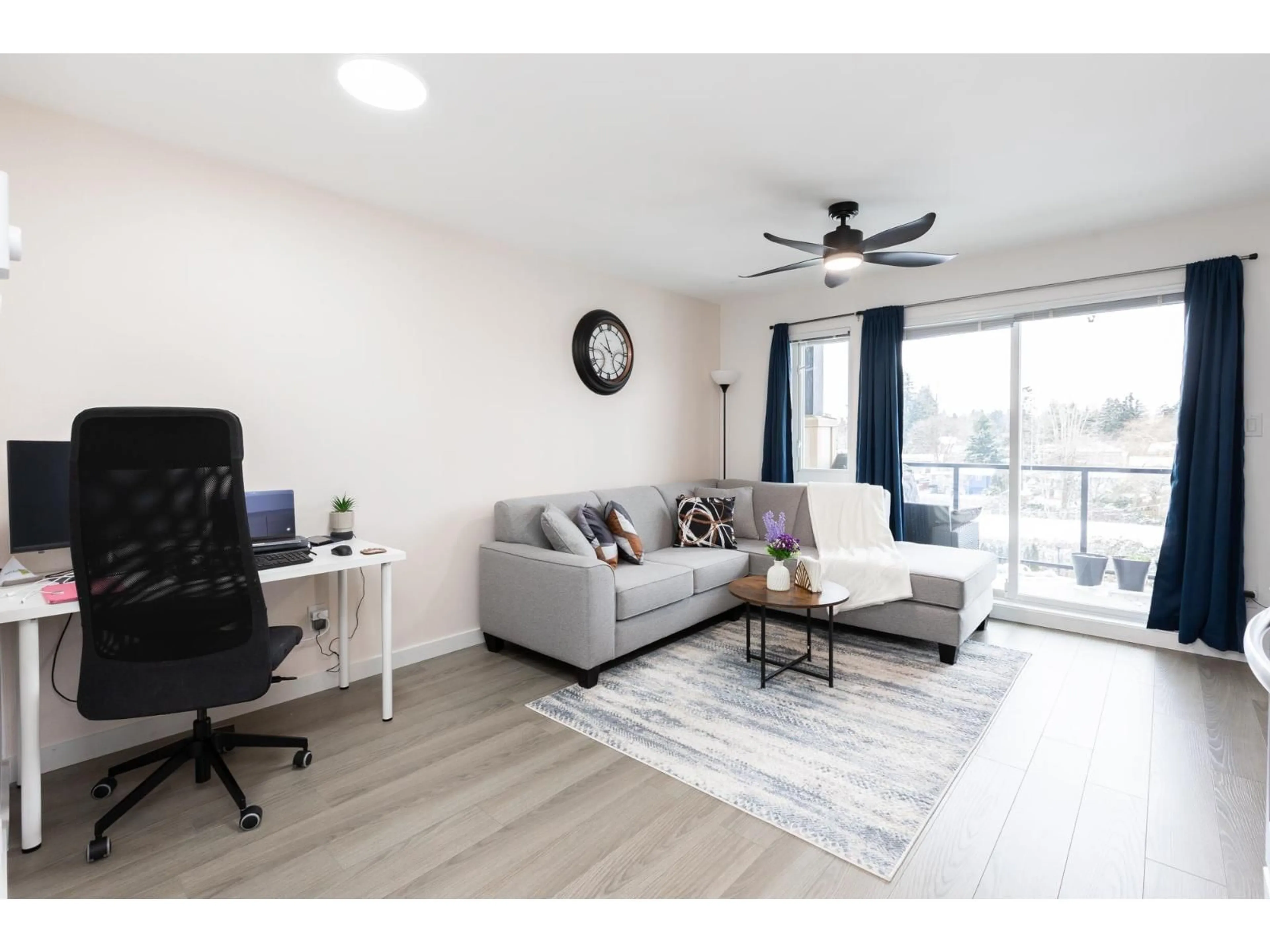Living room with furniture, wood/laminate floor for 408 - 10688 140, Surrey British Columbia V3T4N8