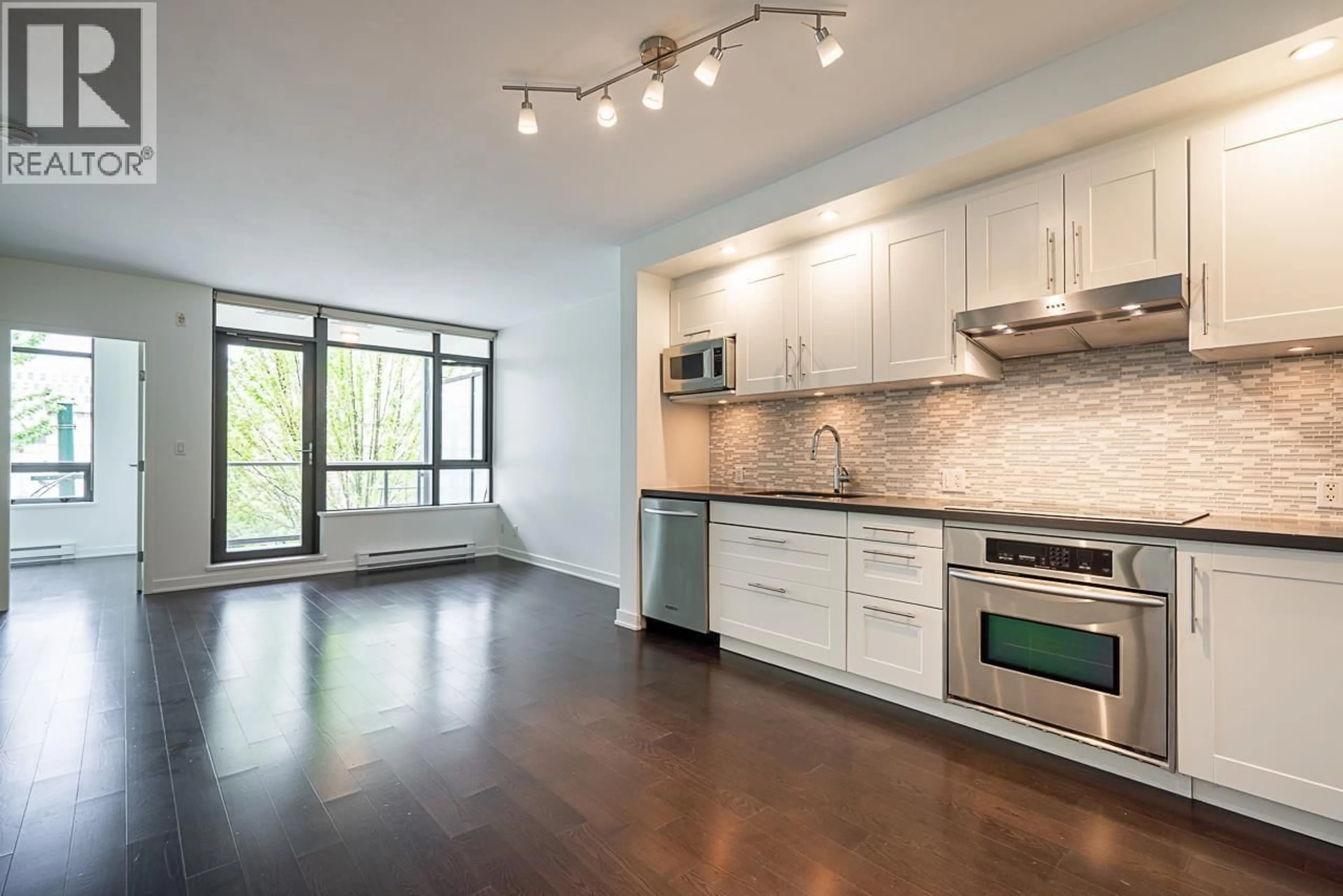 Open concept kitchen, wood/laminate floor for 310 - 750 12TH AVENUE, Vancouver British Columbia V5Z0A3