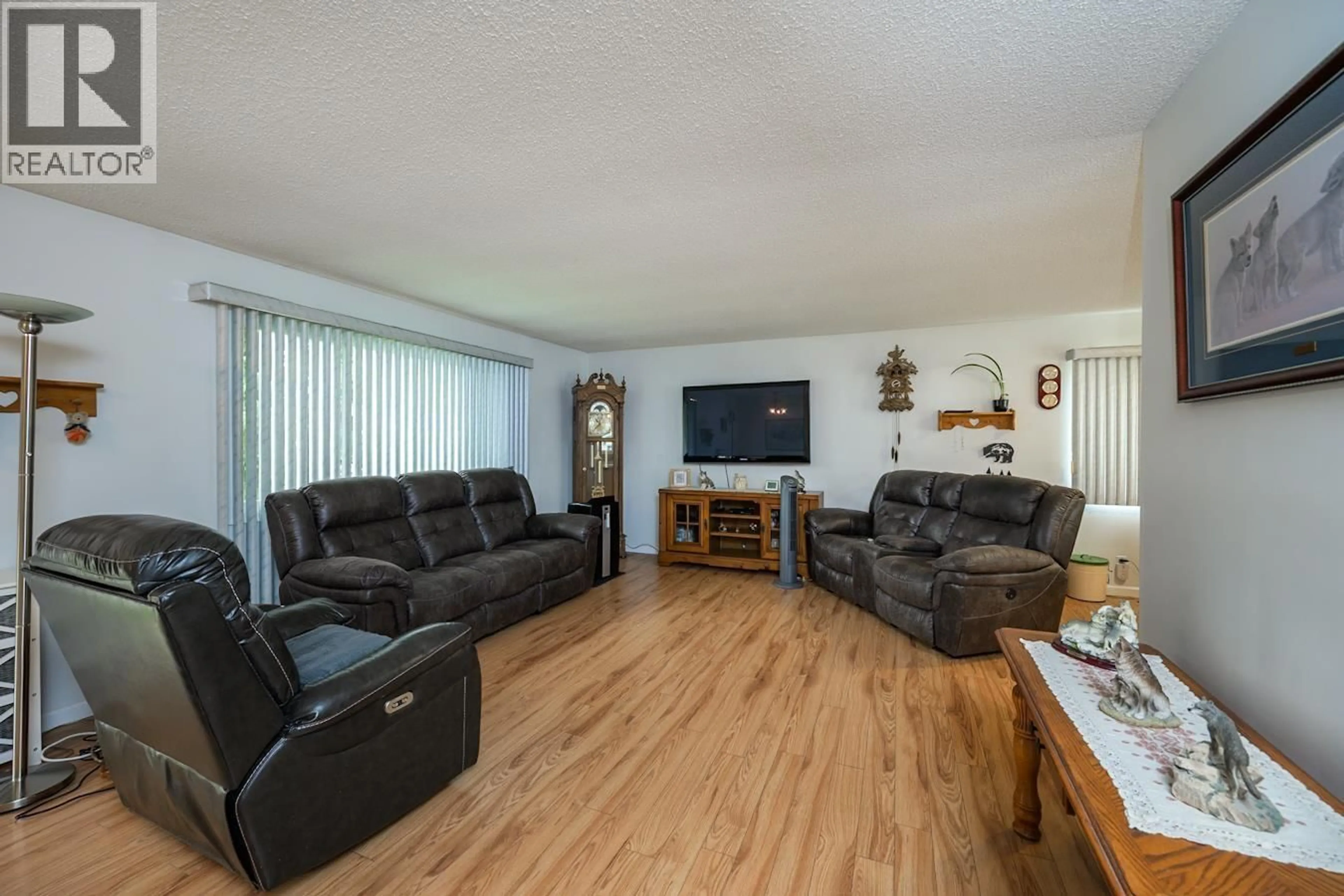 Living room with furniture, wood/laminate floor for 7170 GUELPH PLACE, Prince George British Columbia V2N4A2