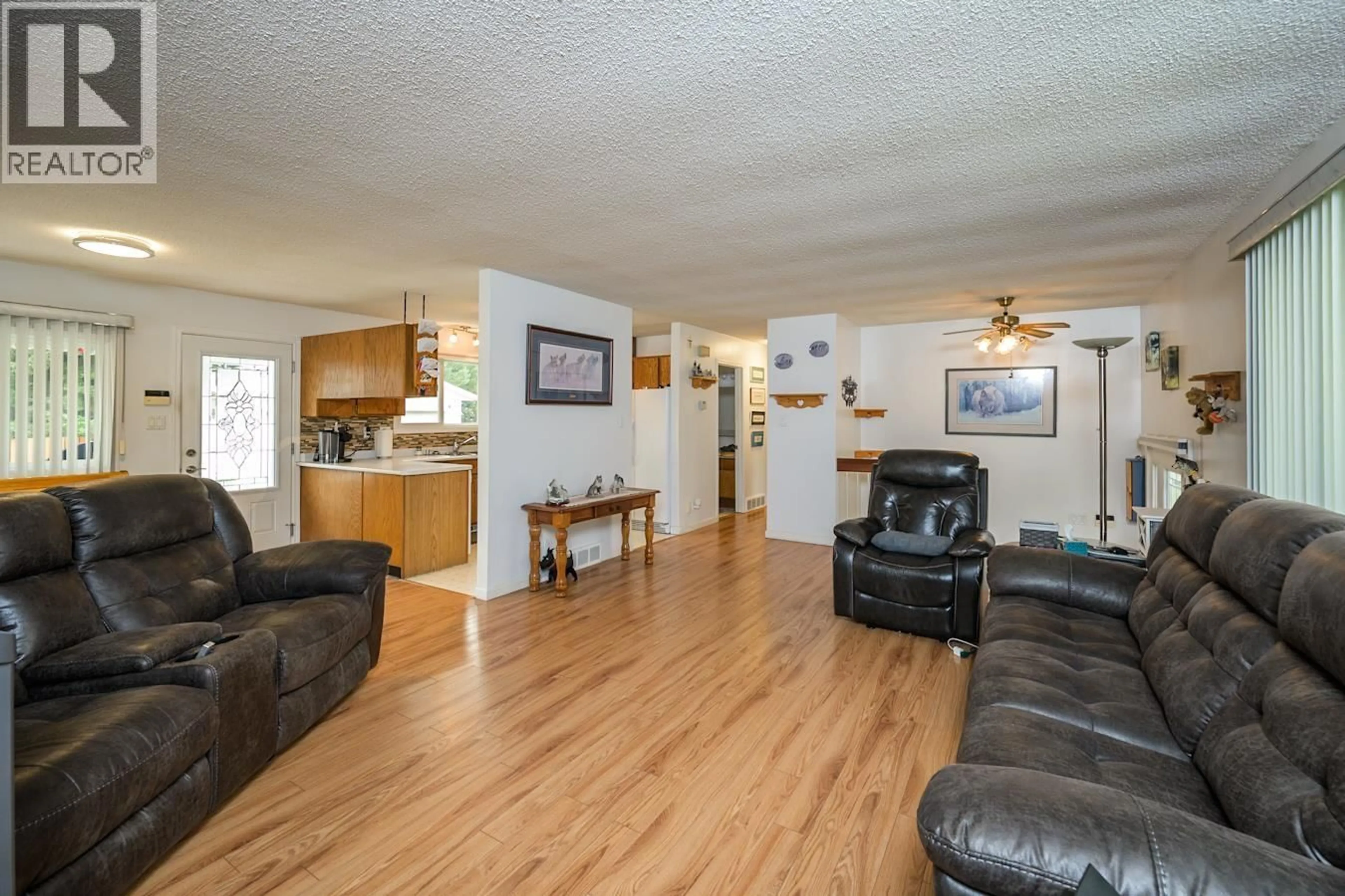 Living room with furniture, wood/laminate floor for 7170 GUELPH PLACE, Prince George British Columbia V2N4A2