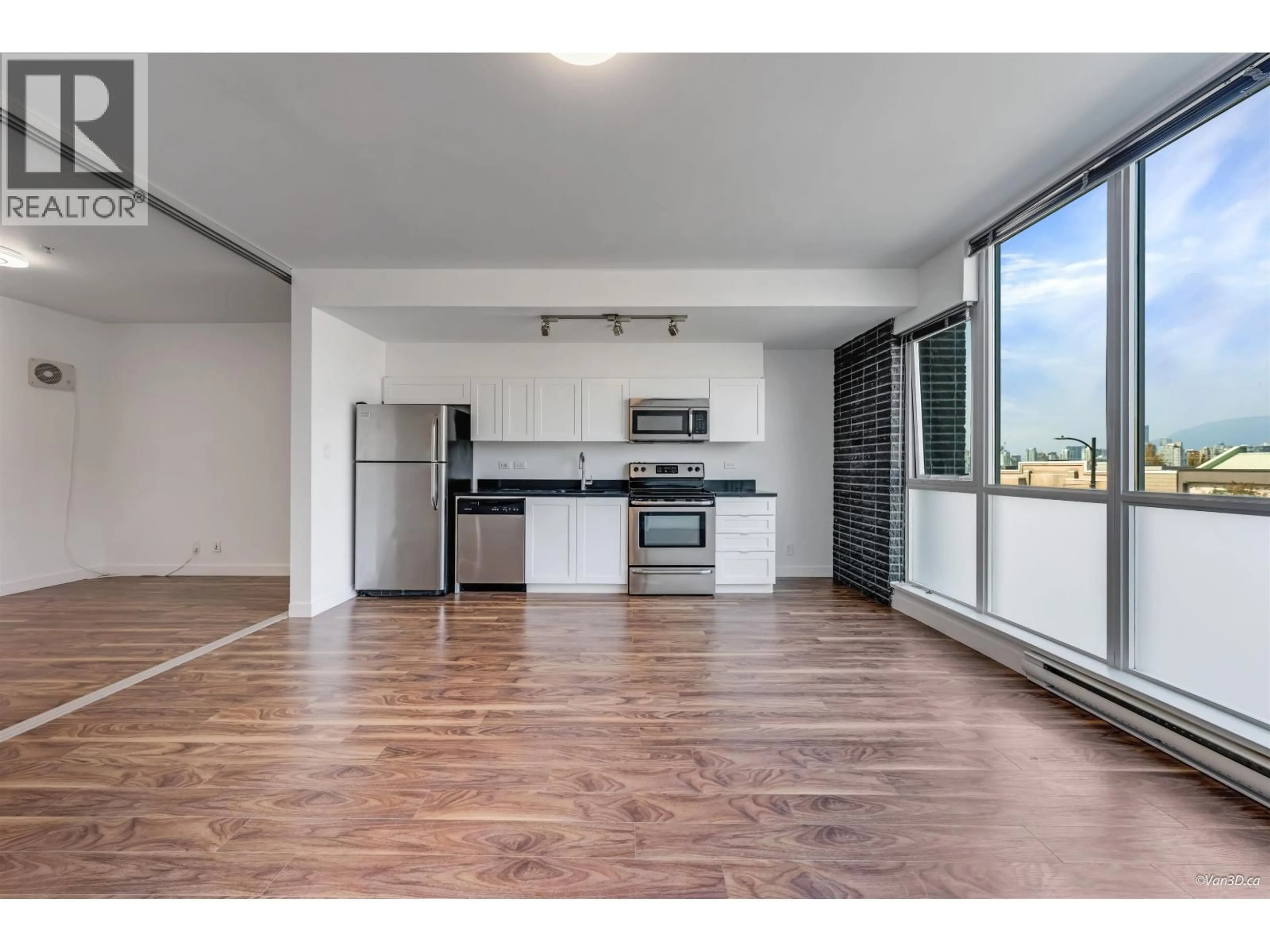 Open concept kitchen, wood/laminate floor for 210 - 2511 QUEBEC STREET, Vancouver British Columbia V5T0B6