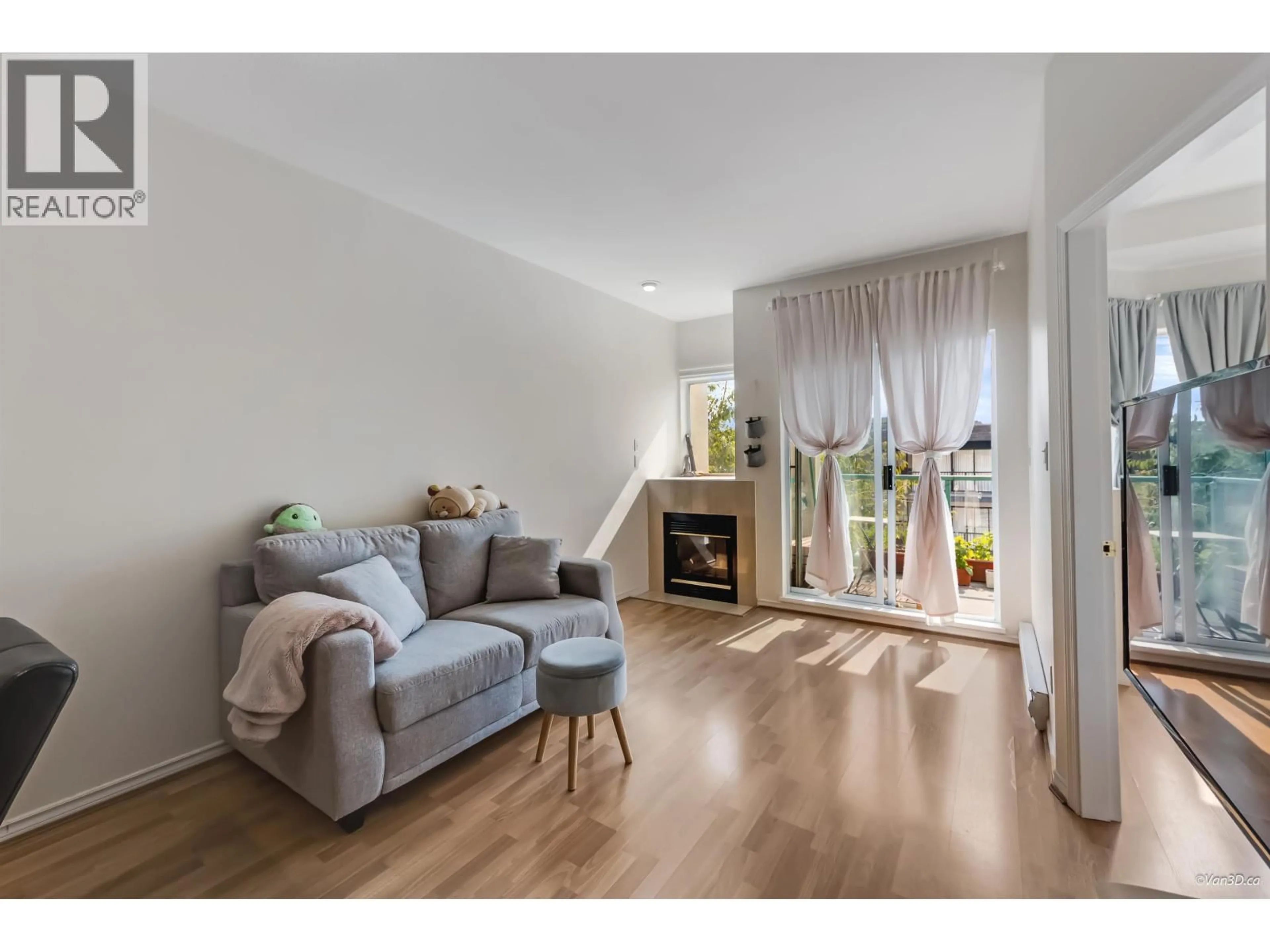 Living room with furniture, wood/laminate floor for 104 - 177 5TH STREET, North Vancouver British Columbia V7M2L7