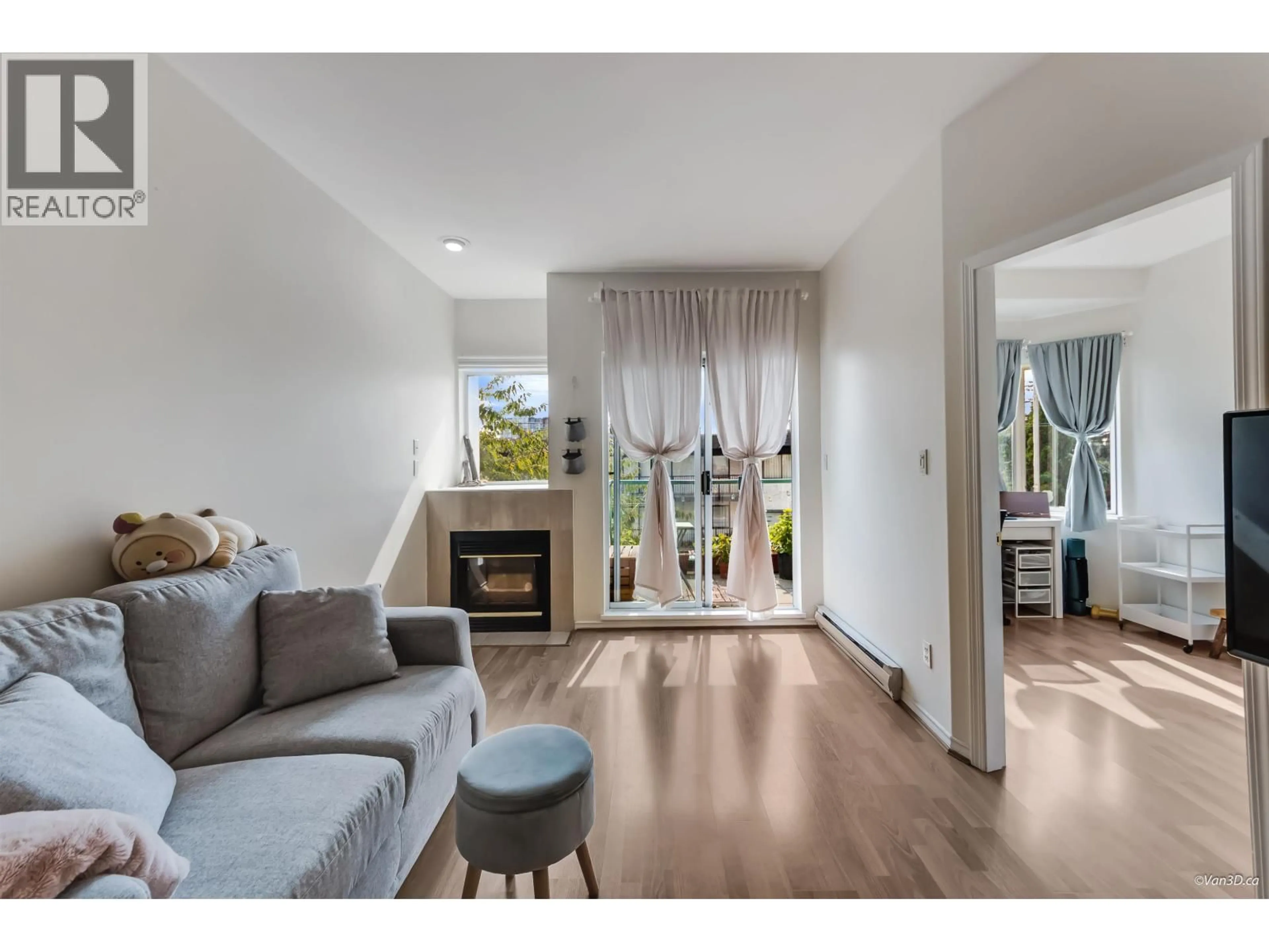 Living room with furniture, wood/laminate floor for 104 - 177 5TH STREET, North Vancouver British Columbia V7M2L7