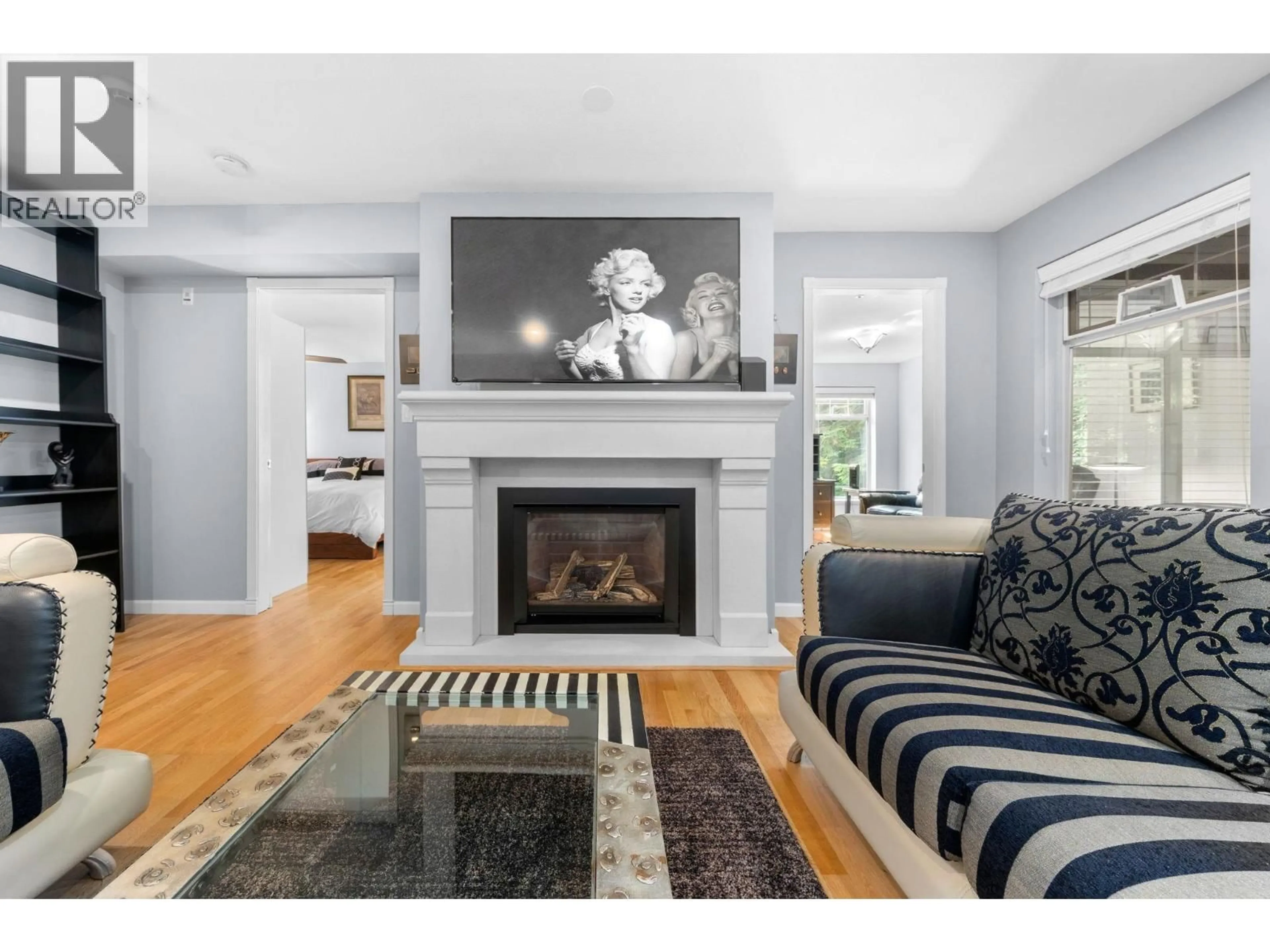 Living room with furniture, wood/laminate floor for 103 - 1144 STRATHAVEN DRIVE, North Vancouver British Columbia V7H2Z6