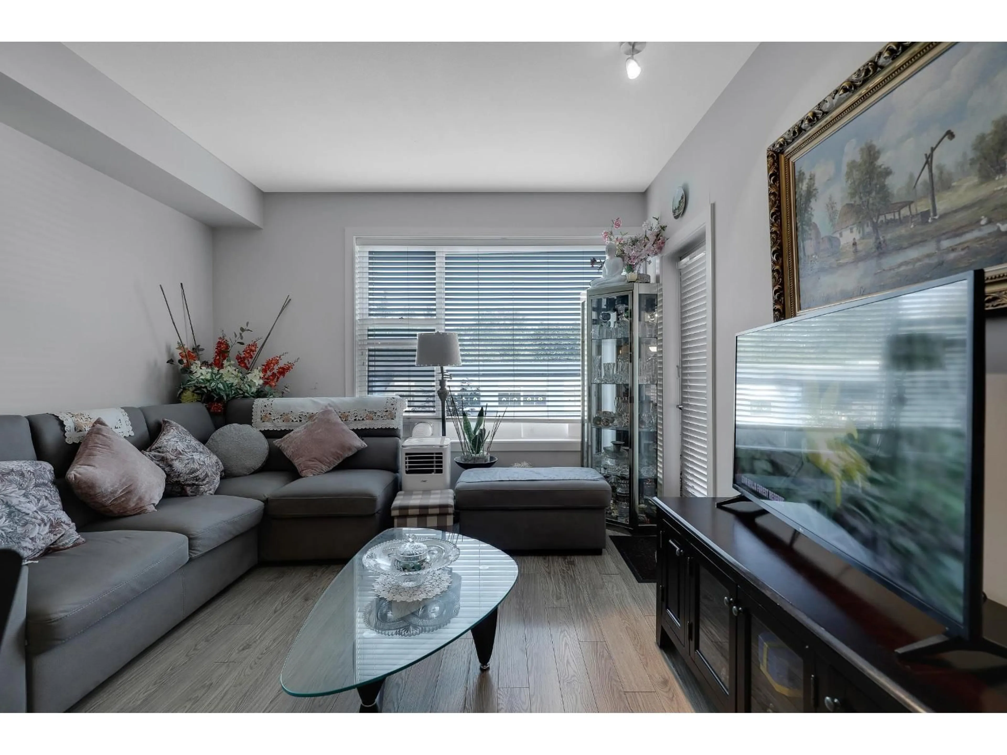 Living room with furniture, wood/laminate floor for 203 - 15956 86A, Surrey British Columbia V4N6N8