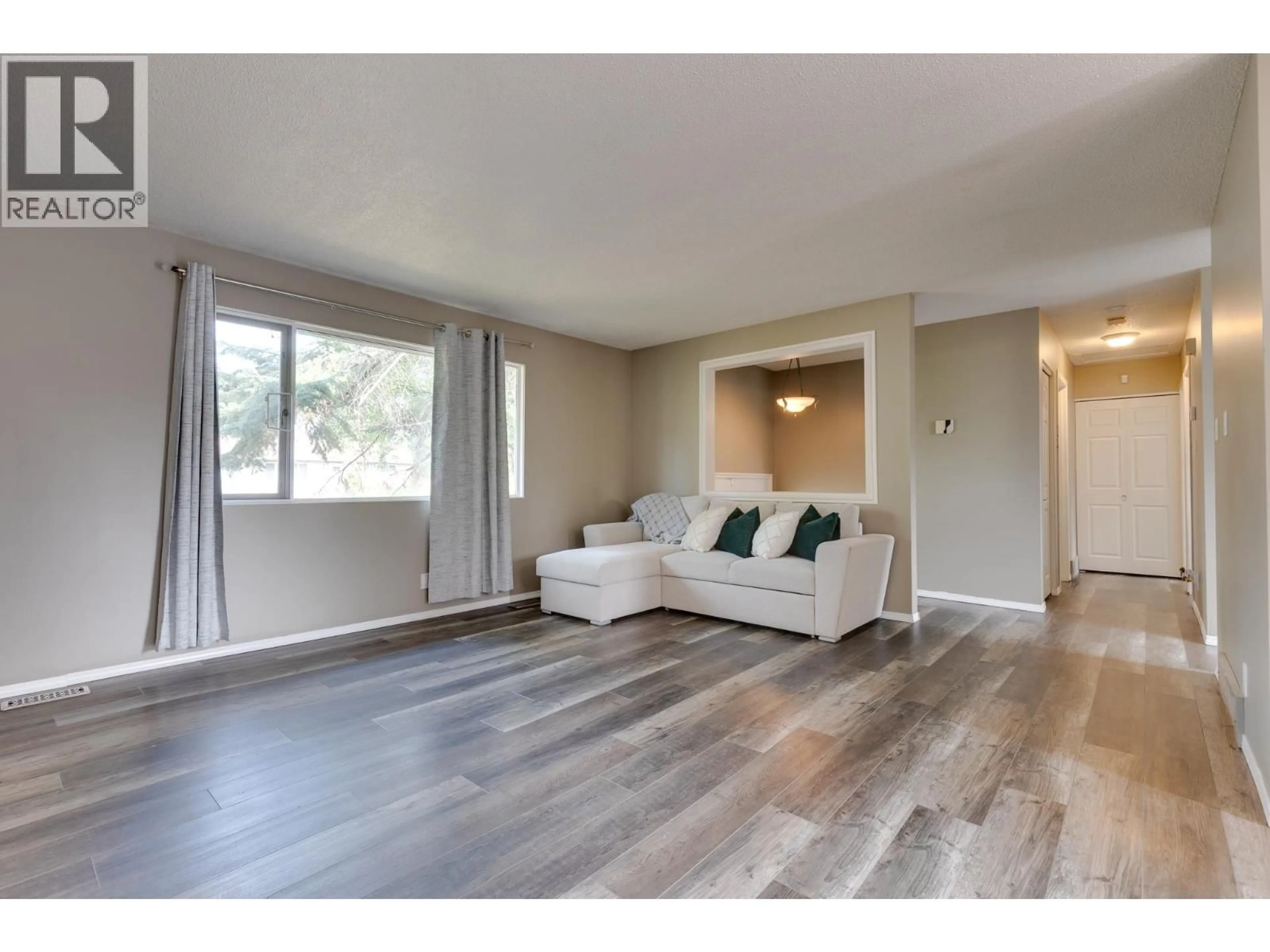 Living room with furniture, wood/laminate floor for 7827 QUEENS CRESCENT, Prince George British Columbia V2N3H3