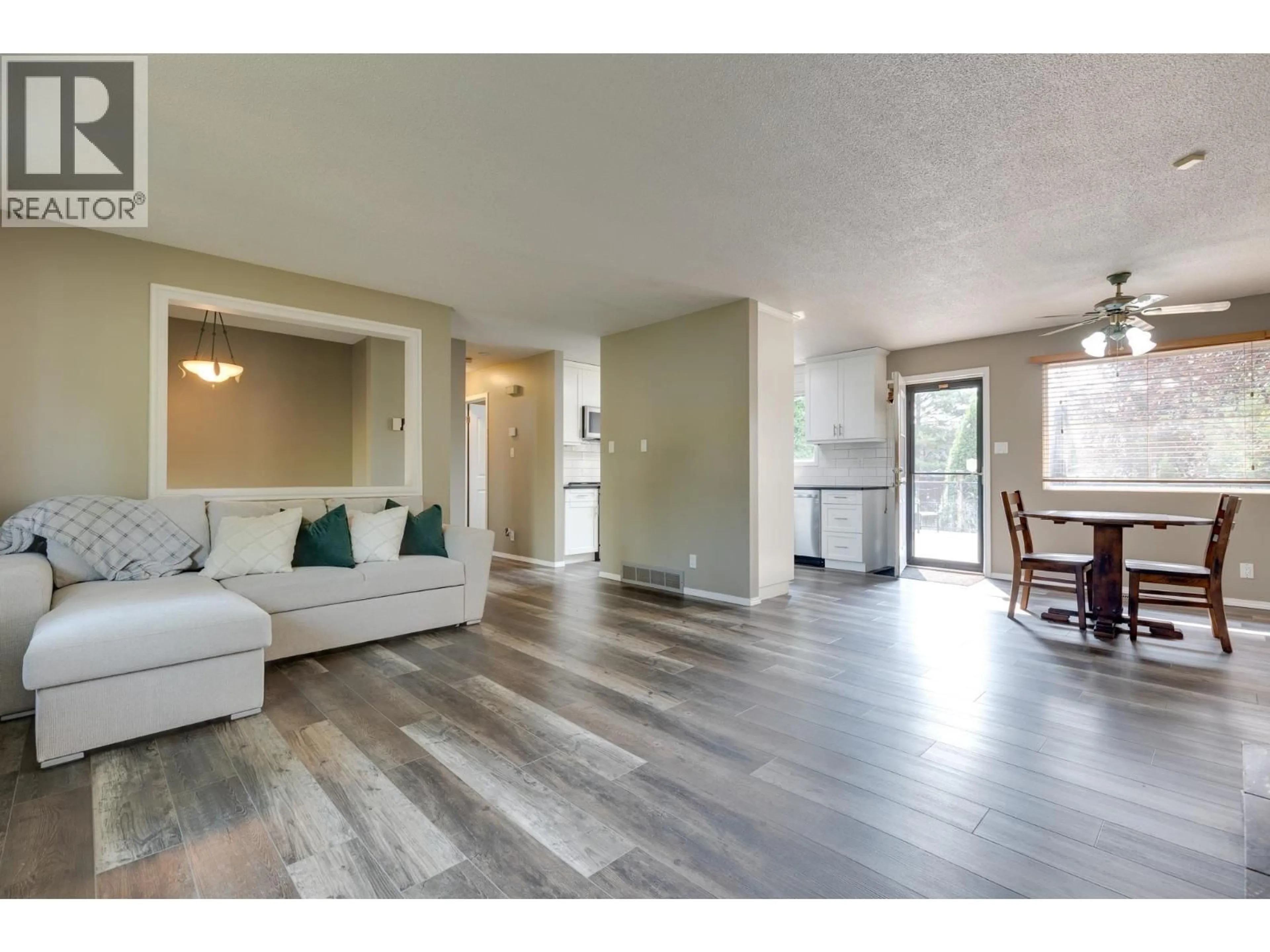 Living room with furniture, wood/laminate floor for 7827 QUEENS CRESCENT, Prince George British Columbia V2N3H3