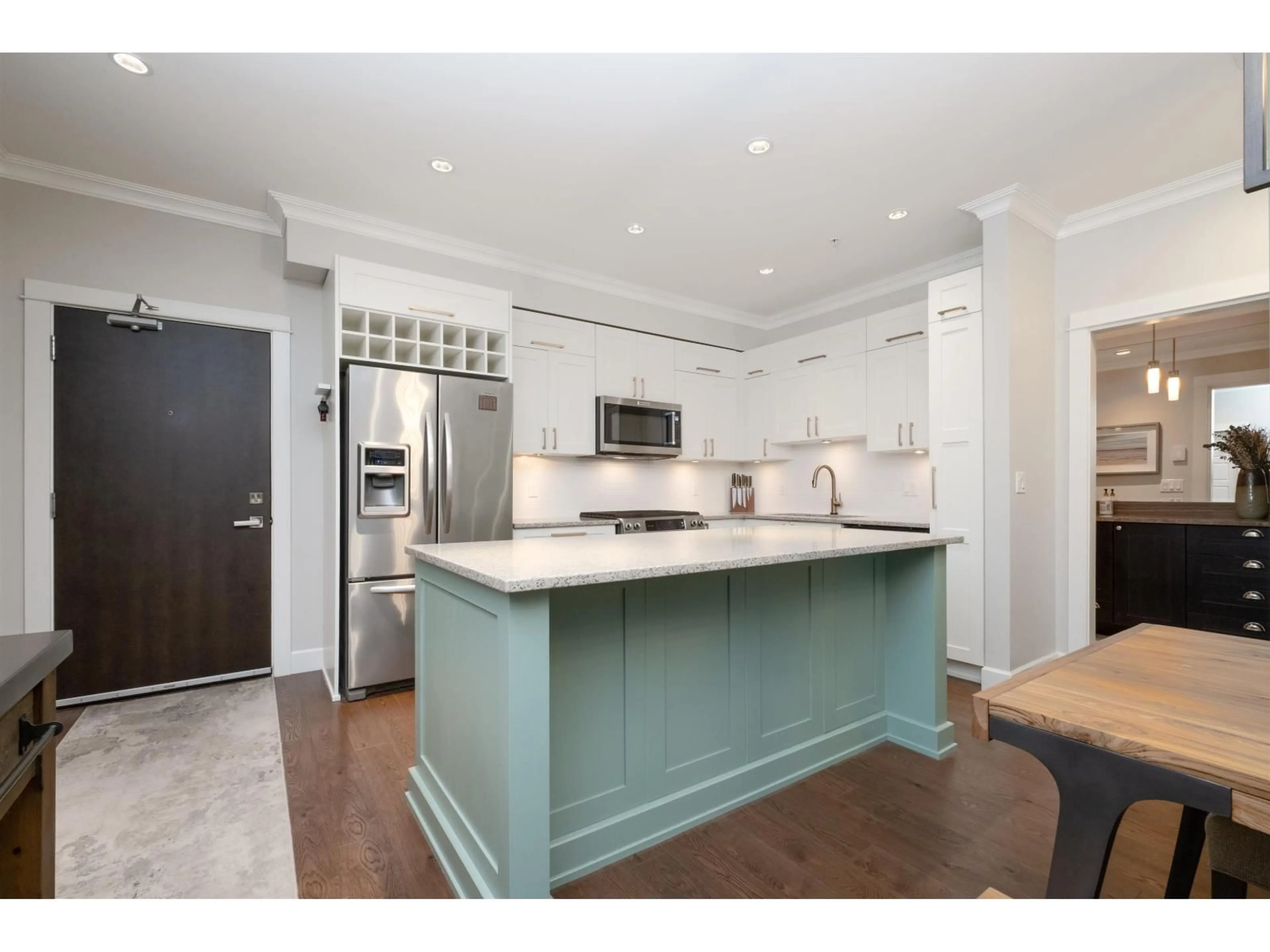 Open concept kitchen, wood/laminate floor for 203 - 15145 36, Surrey British Columbia V3Z4R3