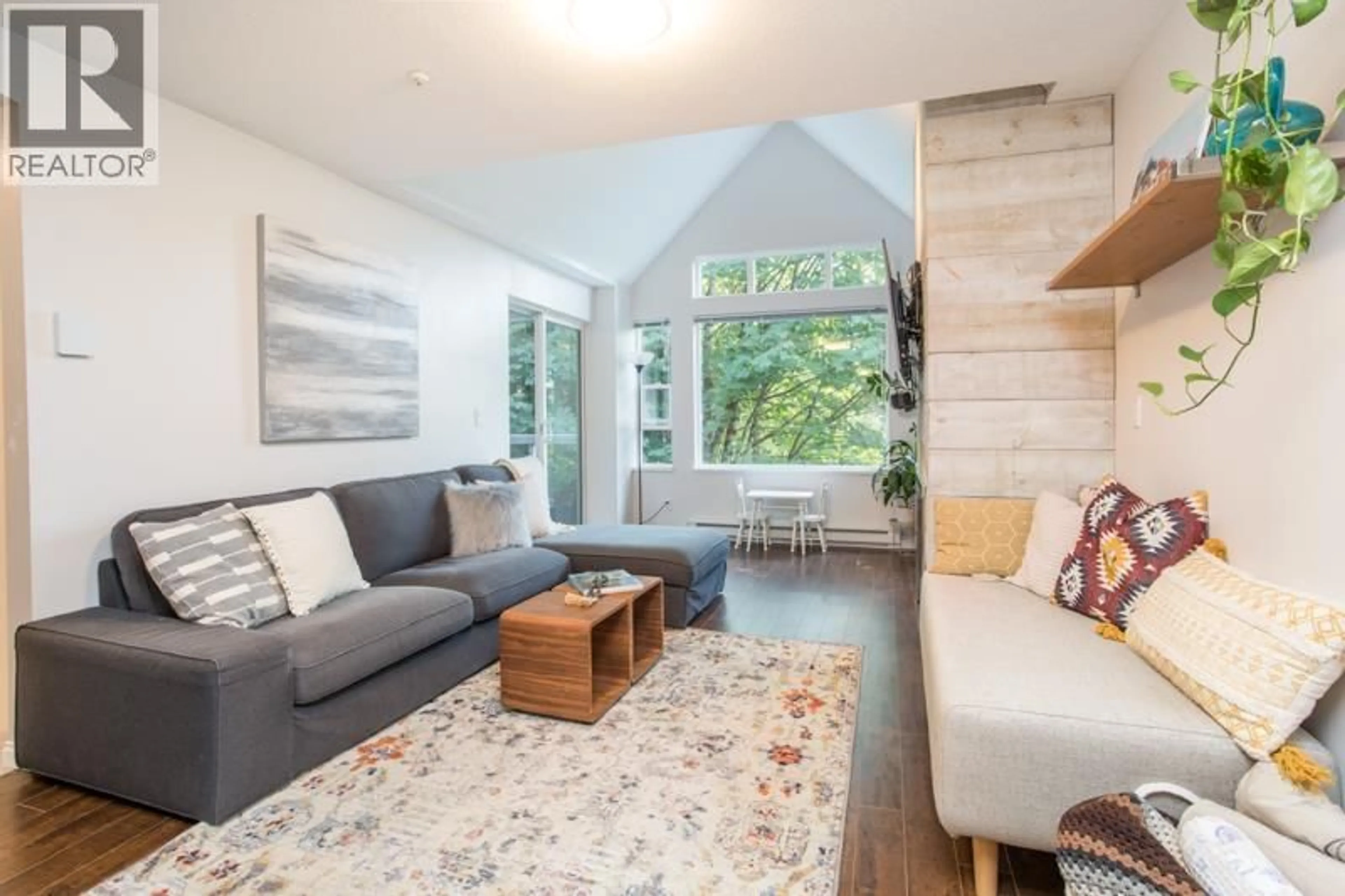 Living room with furniture, wood/laminate floor for 307 - 3033 TERRAVISTA PLACE, Port Moody British Columbia V3H5A3