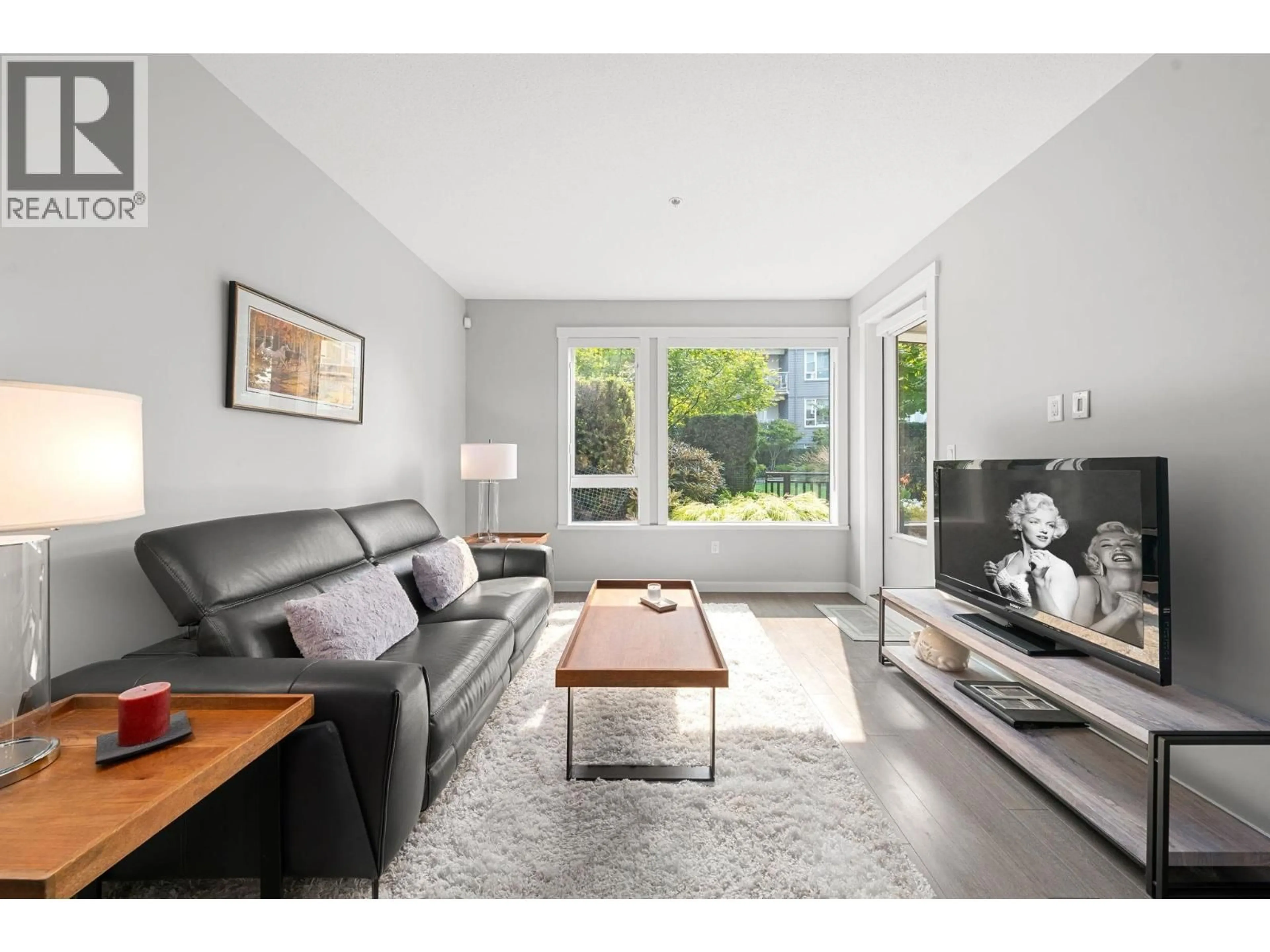 Living room with furniture, wood/laminate floor for 107 - 255 1ST STREET, North Vancouver British Columbia V7M3G8