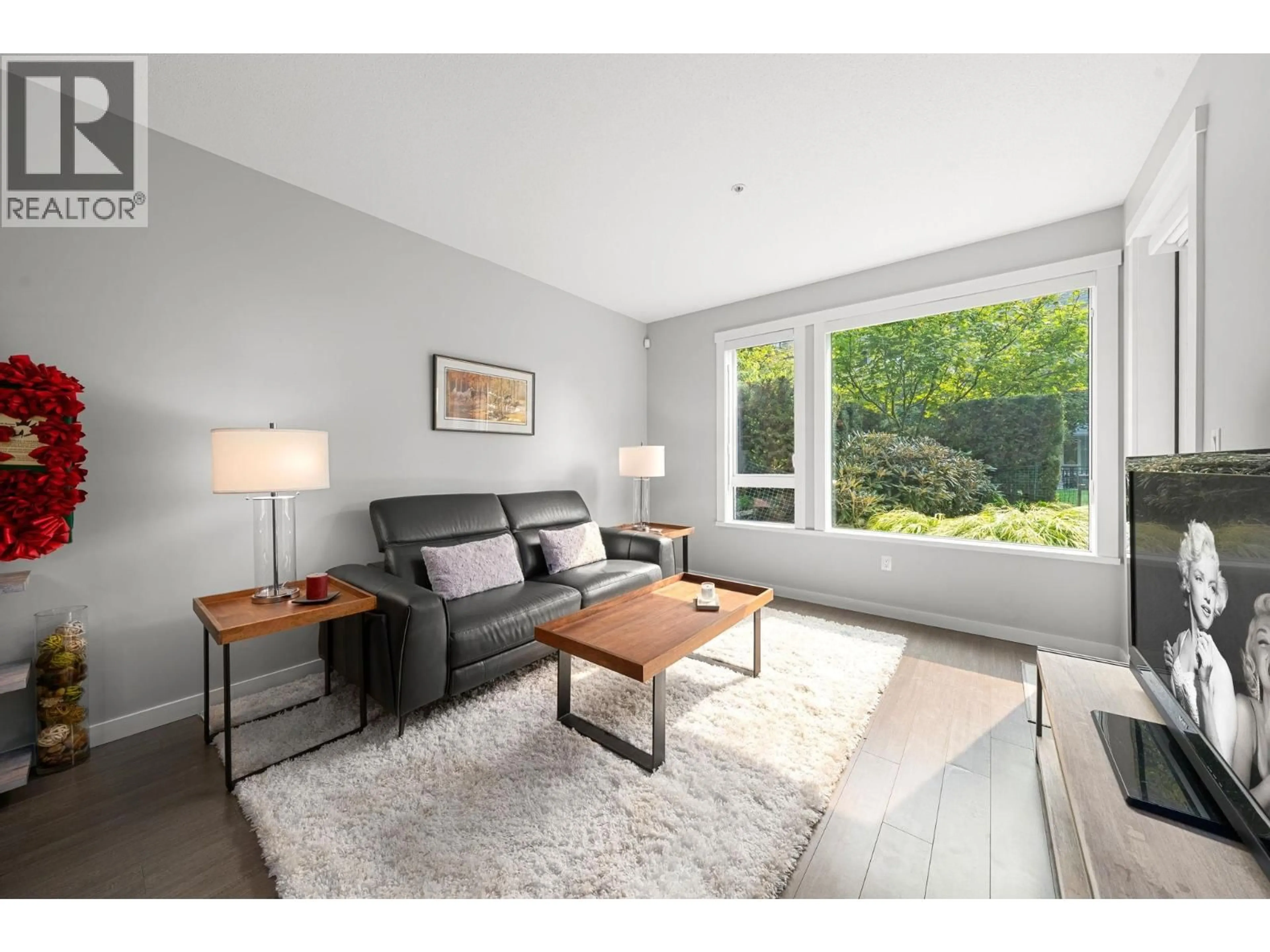 Living room with furniture, wood/laminate floor for 107 - 255 1ST STREET, North Vancouver British Columbia V7M3G8
