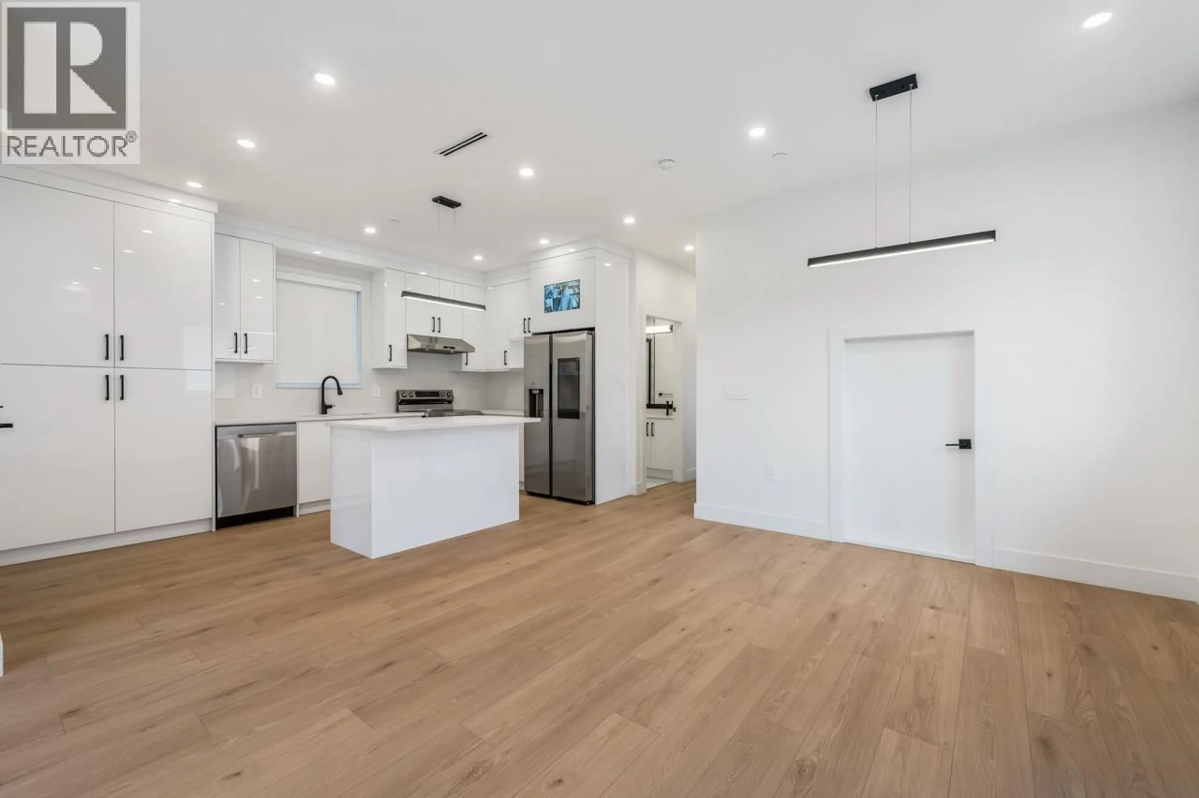 Open concept kitchen, wood/laminate floor for 1 - 3096 VANNESS AVENUE, Vancouver British Columbia V5R5A1