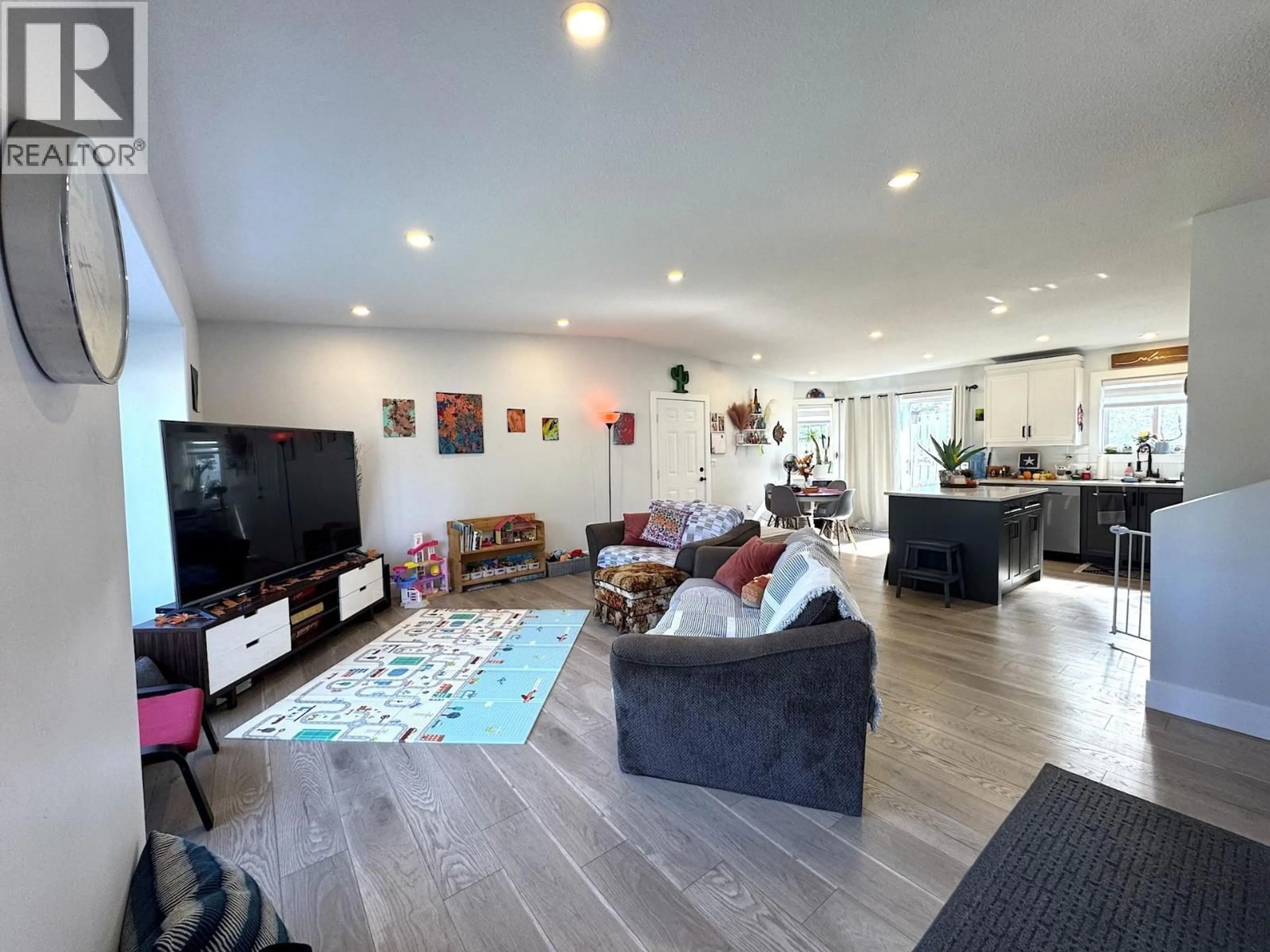 Living room with furniture, wood/laminate floor for 8815 87 AVENUE, Fort St. John British Columbia V1J6C3