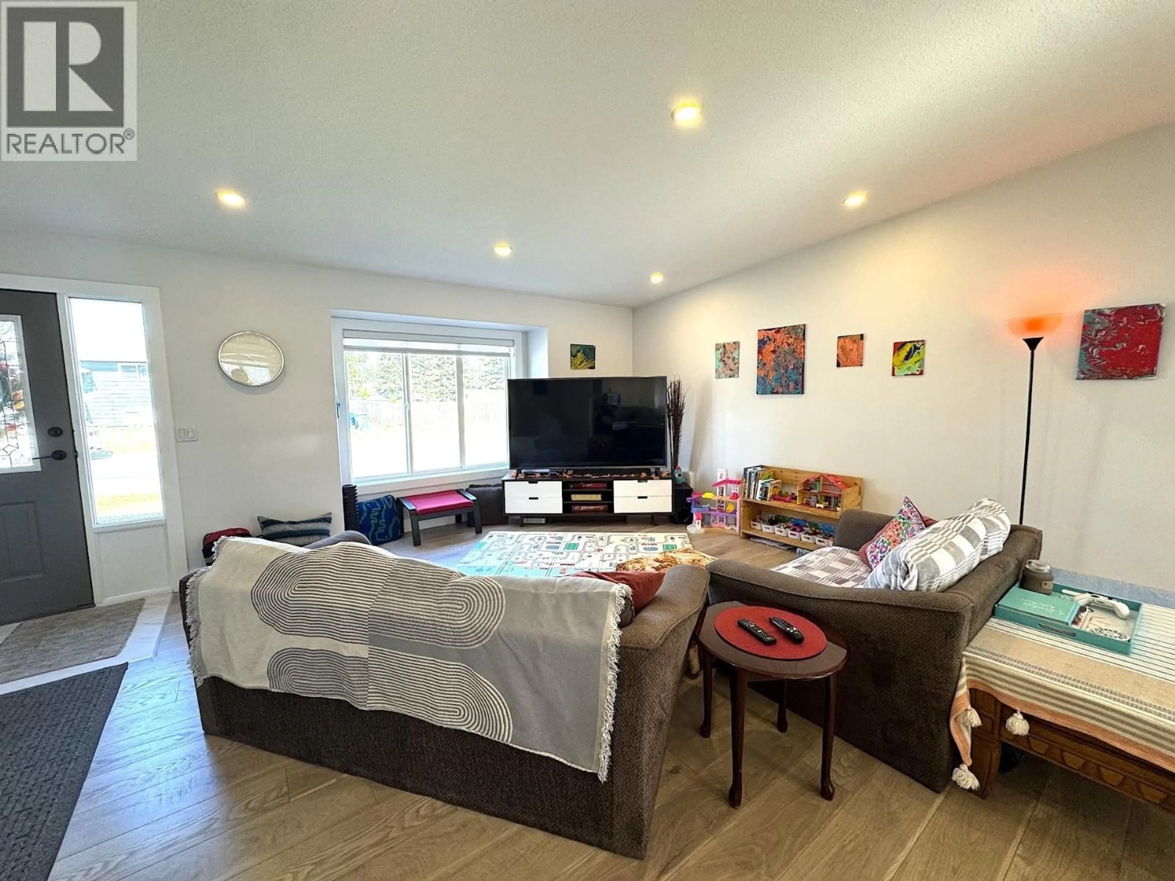 Living room with furniture, wood/laminate floor for 8815 87 AVENUE, Fort St. John British Columbia V1J6C3