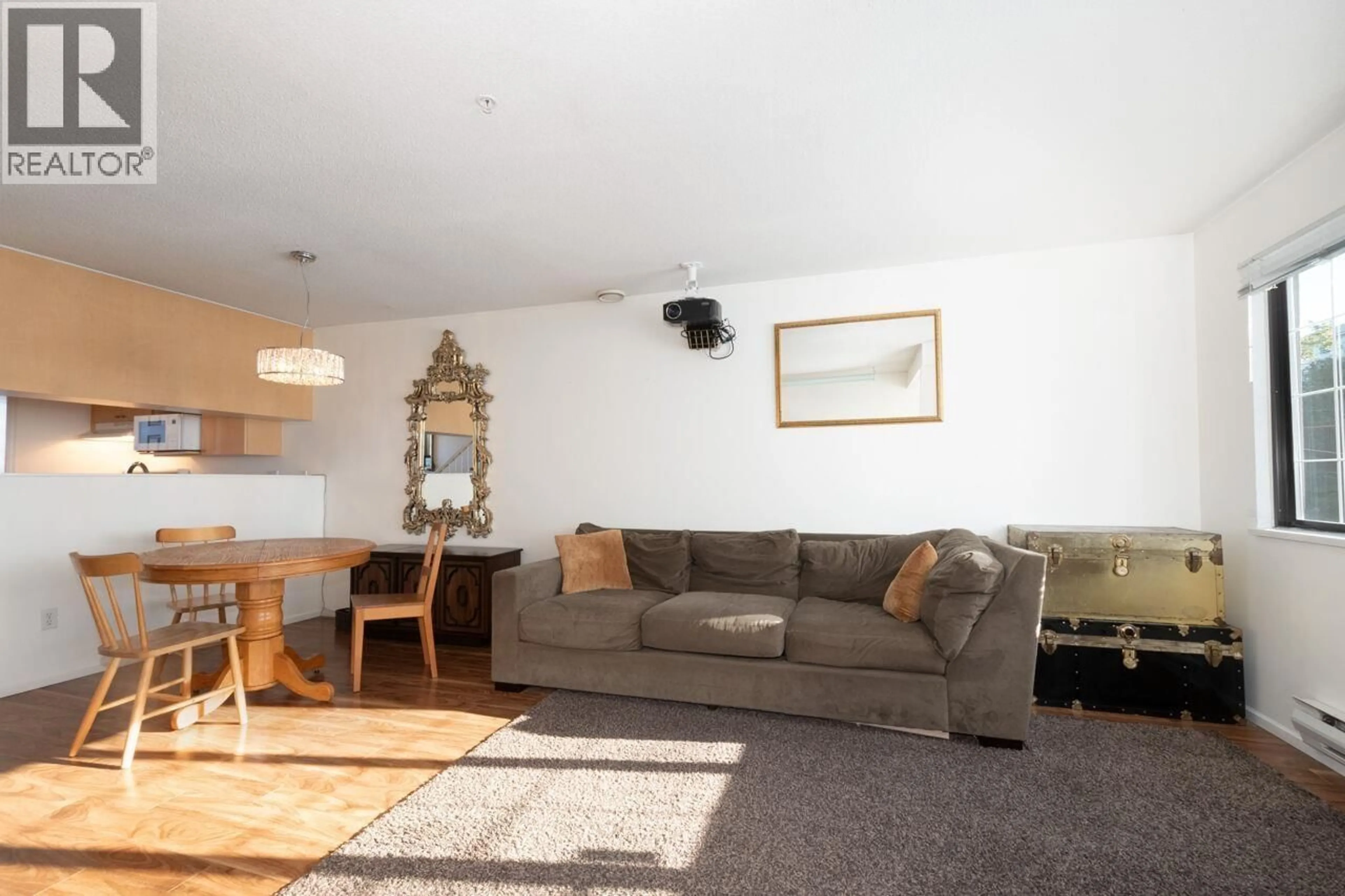 Living room with furniture, wood/laminate floor for 203 - 3368 MAIN STREET, Vancouver British Columbia V5V3M7