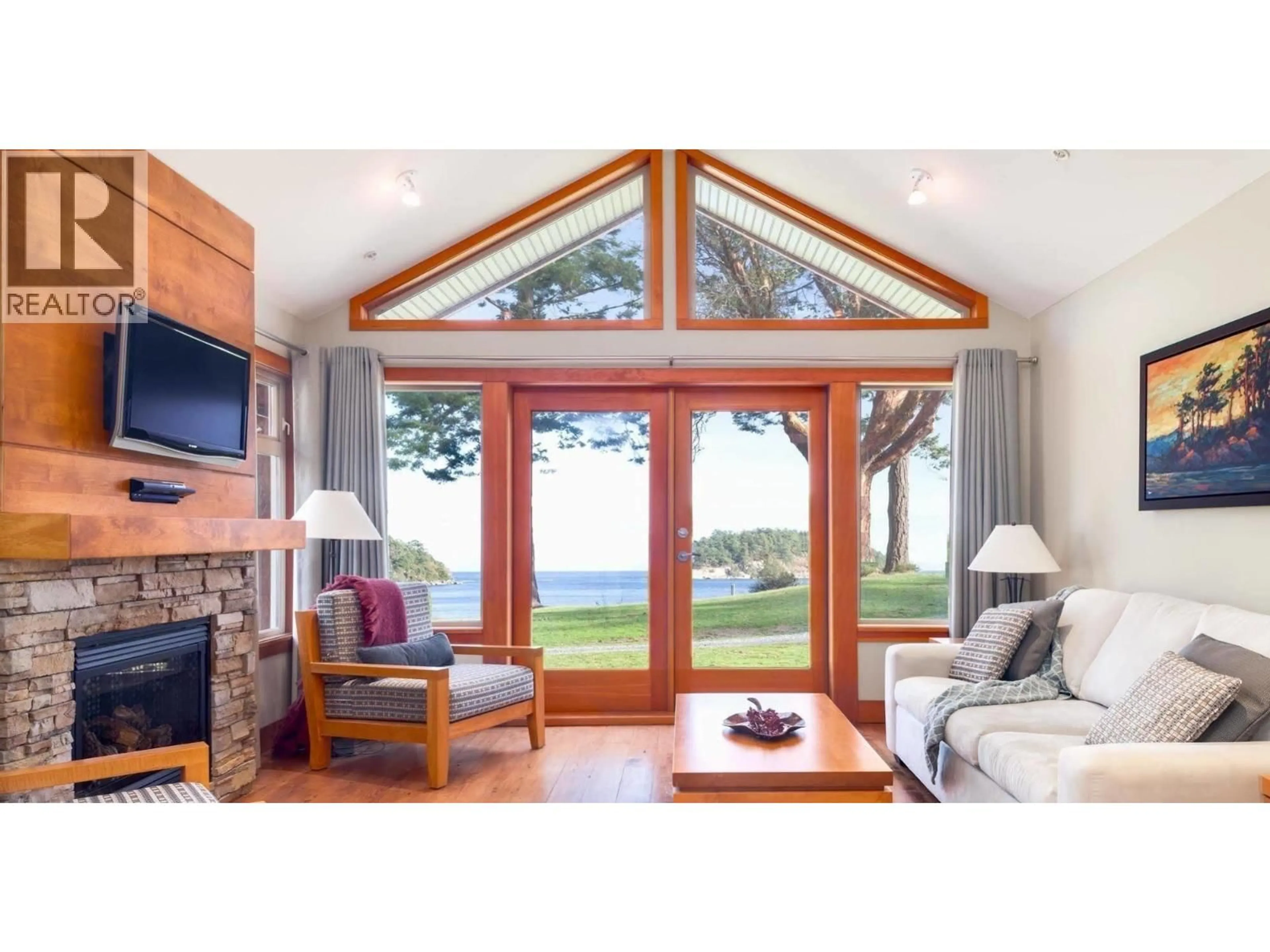 Living room with furniture, wood/laminate floor for 105A - 494 ARBUTUS DRIVE, Mayne Island British Columbia V0N2J1