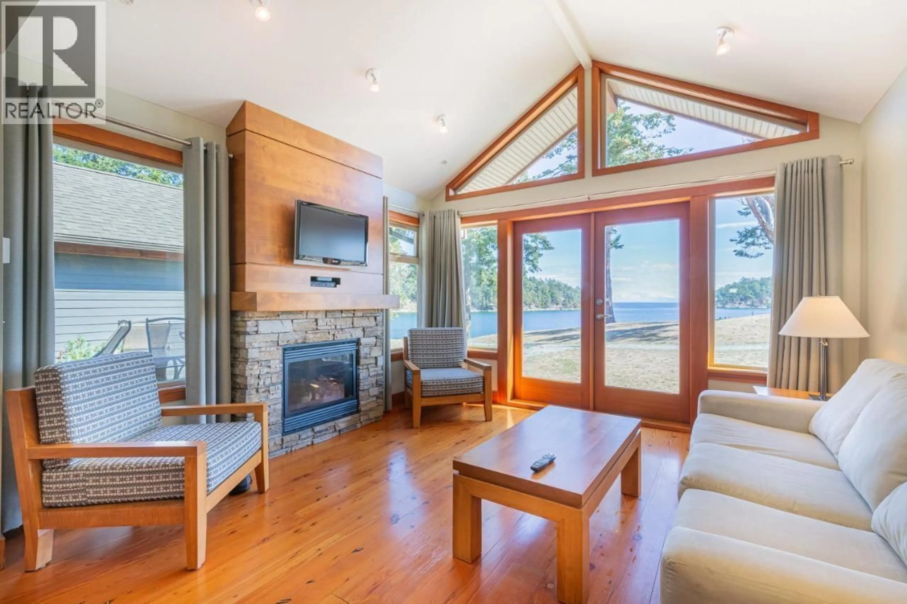 Living room with furniture, wood/laminate floor for 105A - 494 ARBUTUS DRIVE, Mayne Island British Columbia V0N2J1