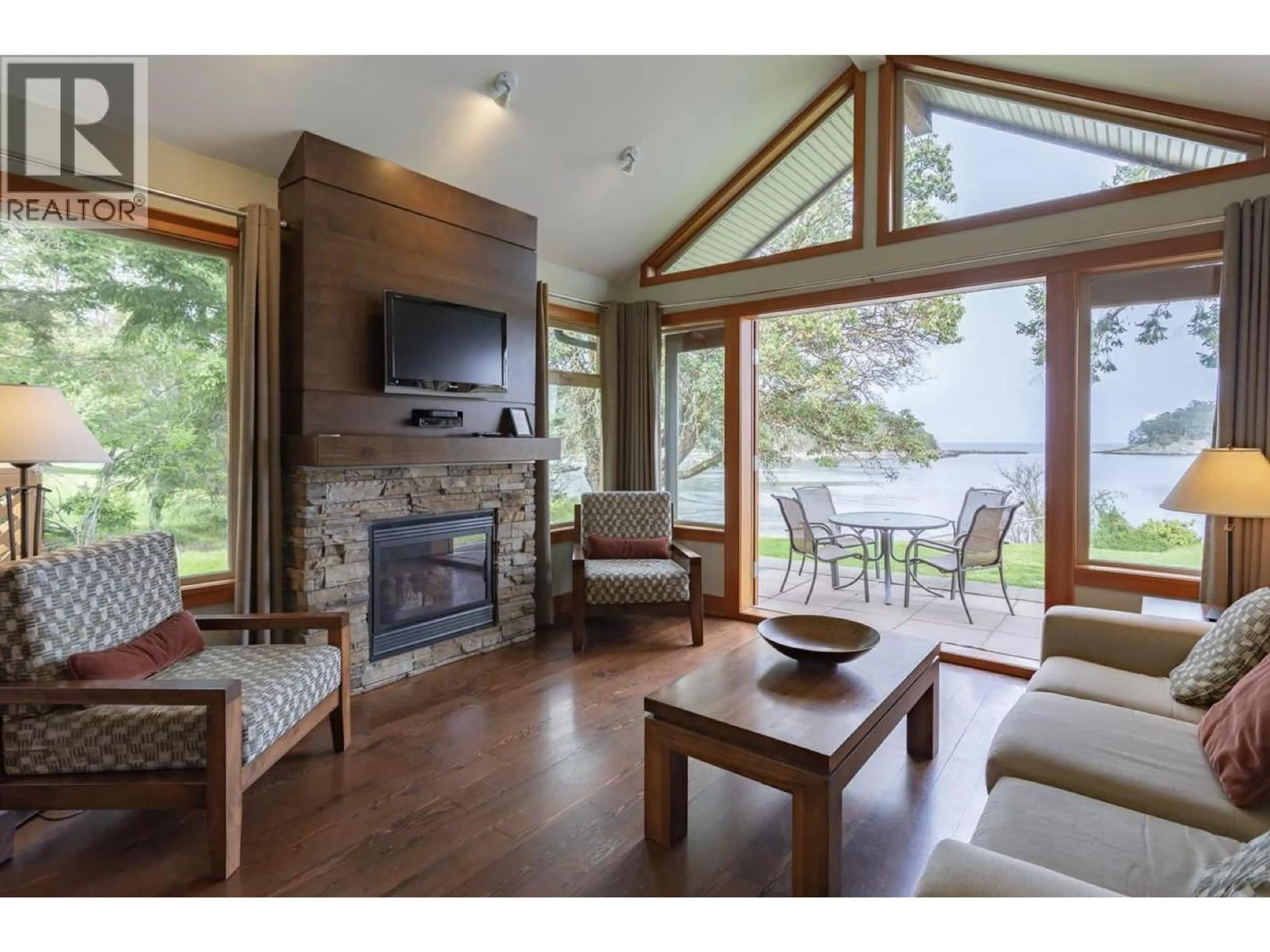 Living room with furniture, wood/laminate floor for 105A - 494 ARBUTUS DRIVE, Mayne Island British Columbia V0N2J1