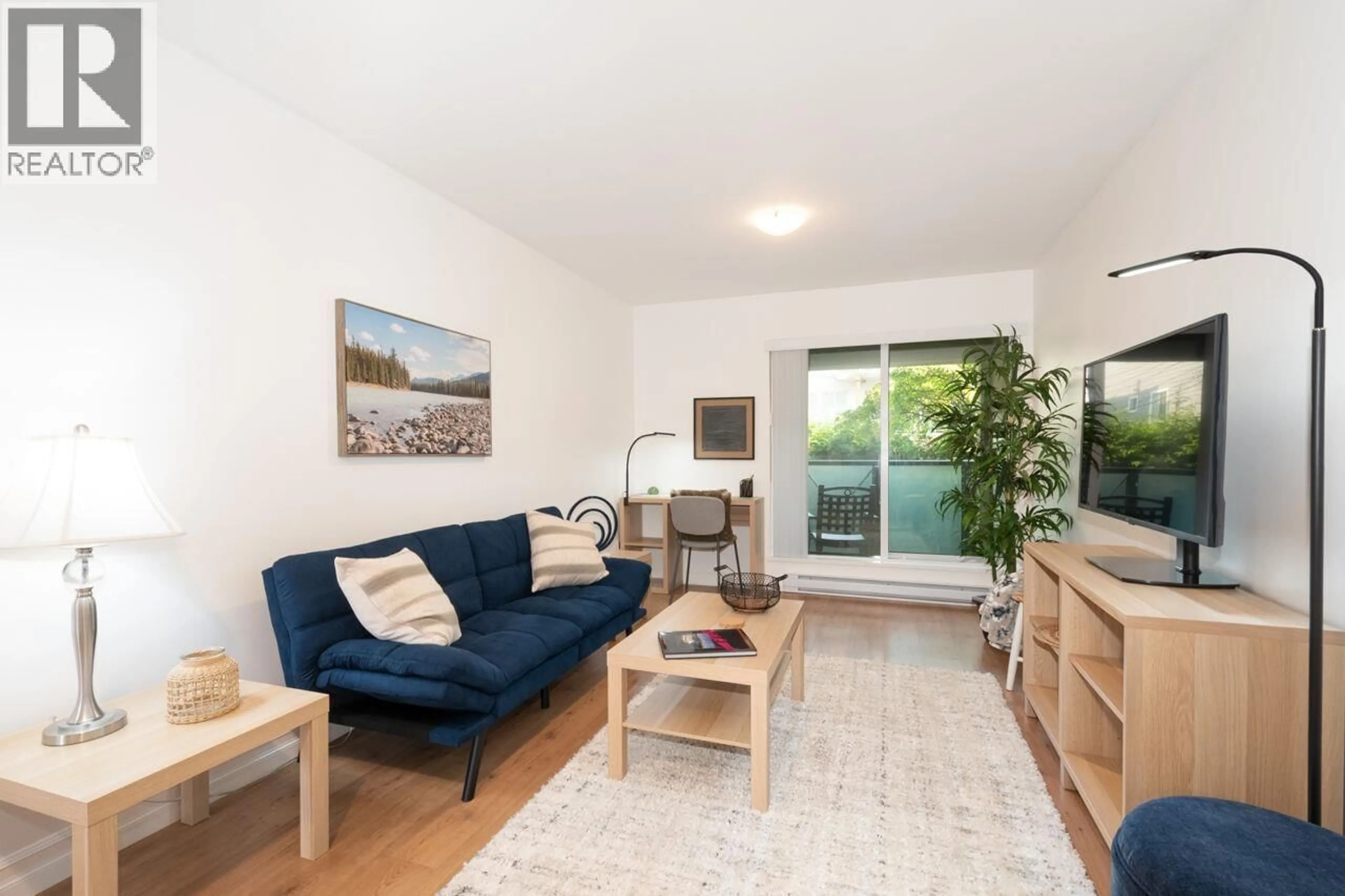 Living room with furniture, wood/laminate floor for 214 - 140 4TH STREET, North Vancouver British Columbia V7L4R1