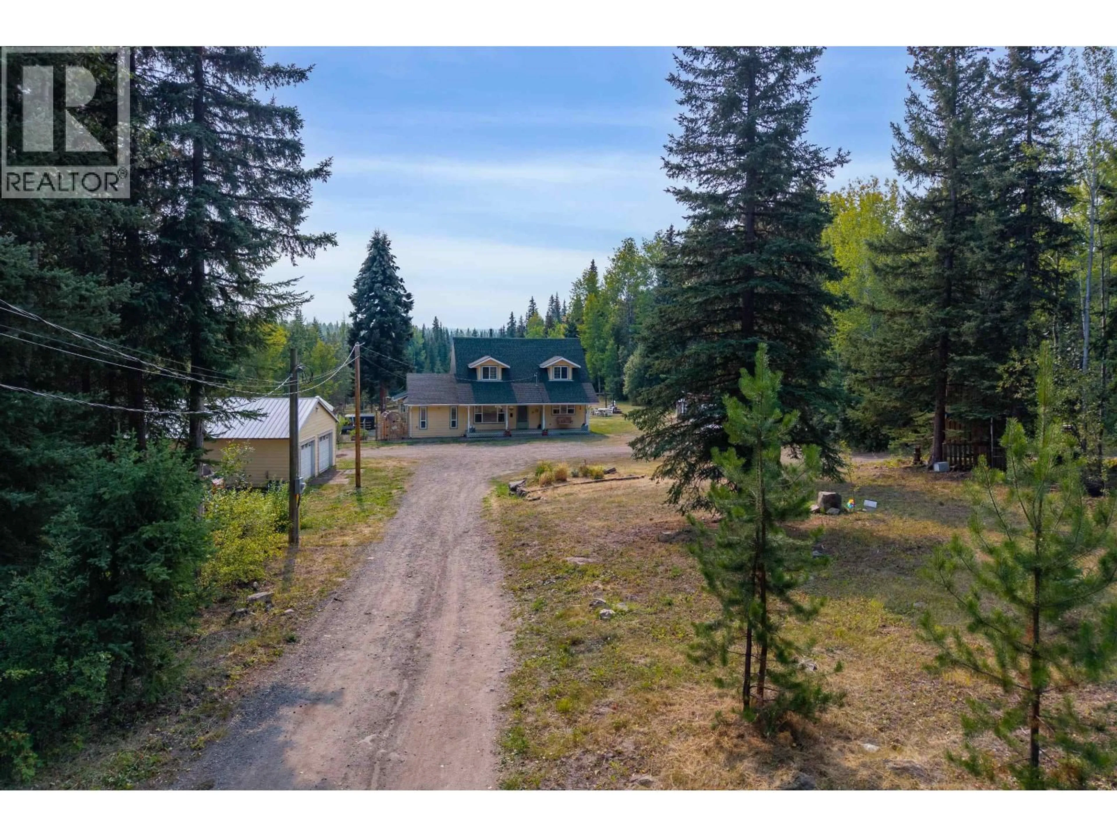 A pic from outside/outdoor area/front of a property/back of a property/a pic from drone, forest/trees view for 7492 FRASER WAY, Bridge Lake British Columbia V0K1X1
