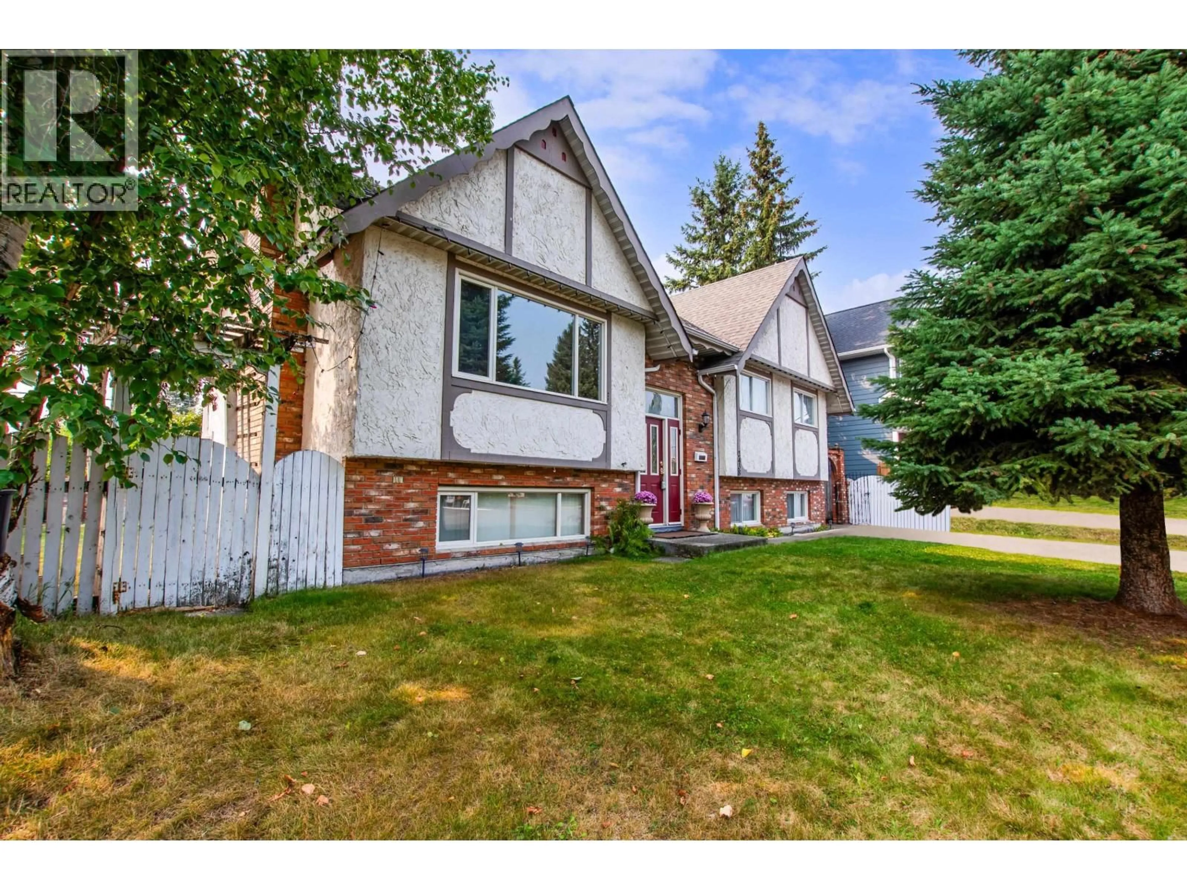 Home with vinyl exterior material, street for 2438 MCBRIDE CRESCENT, Prince George British Columbia V2M2A1