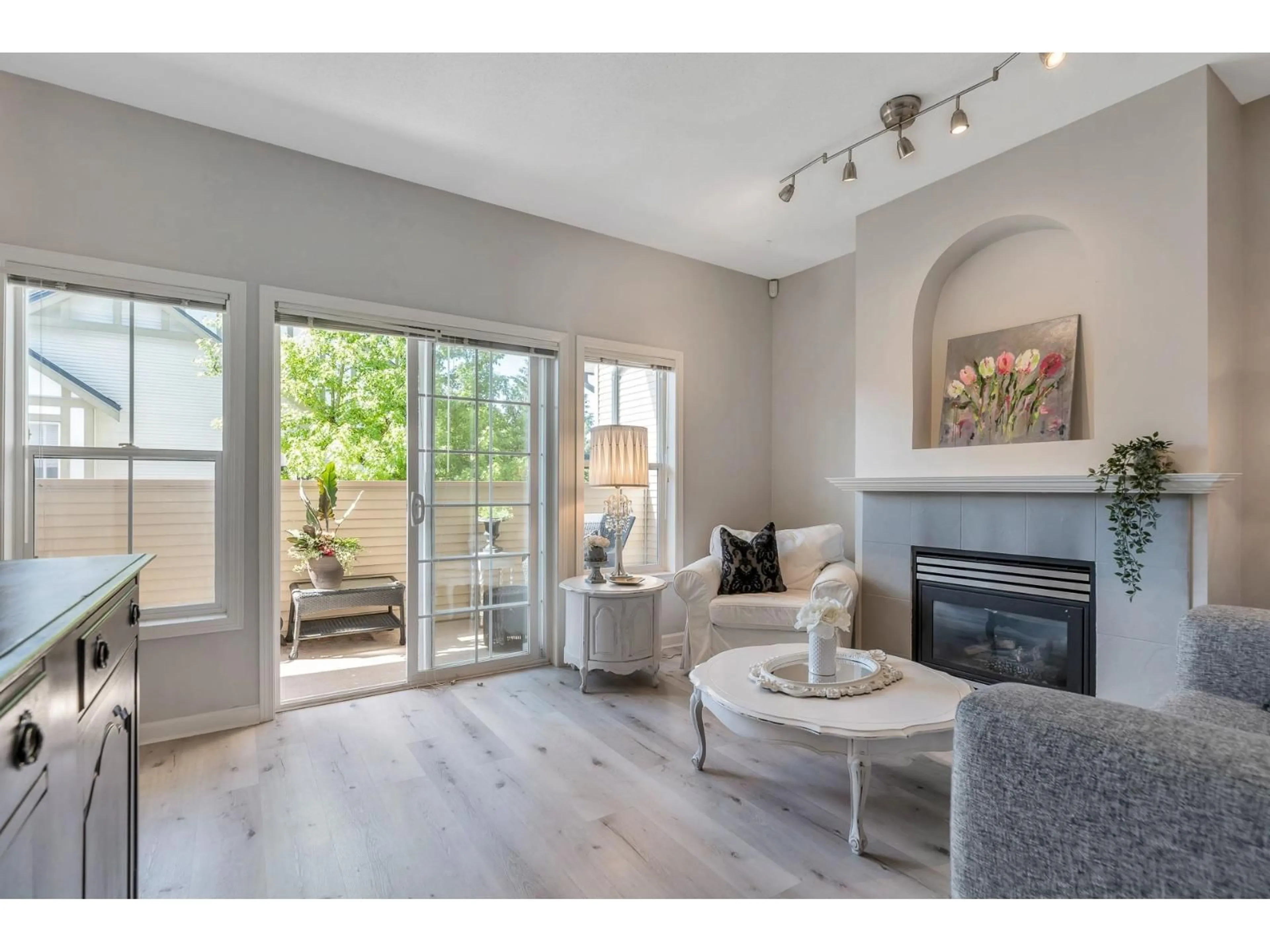 Living room with furniture, wood/laminate floor for 16 - 18707 65, Surrey British Columbia V3S9H2