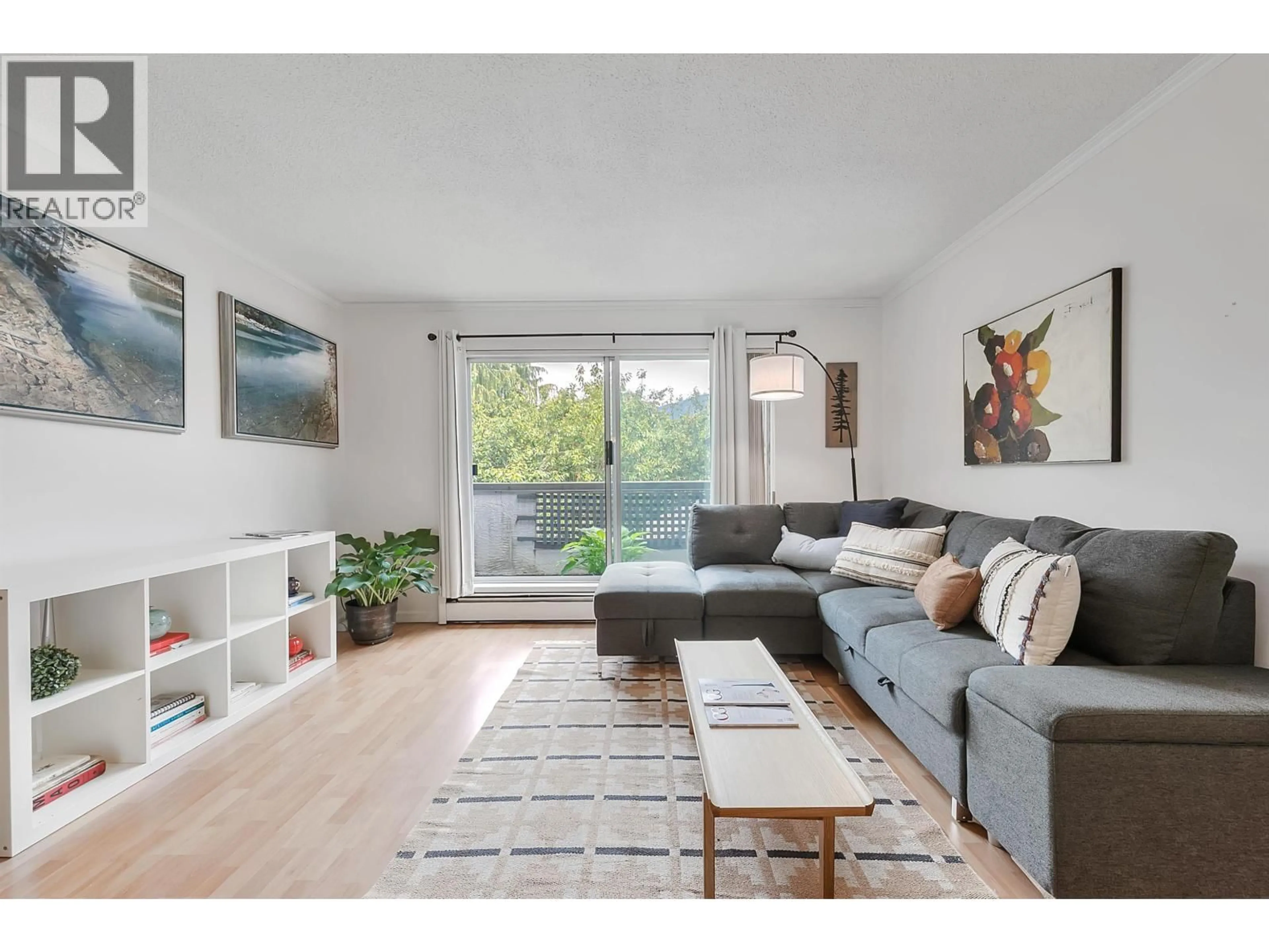 Living room with furniture, wood/laminate floor for 301 - 809 16TH STREET, North Vancouver British Columbia V7P1R2