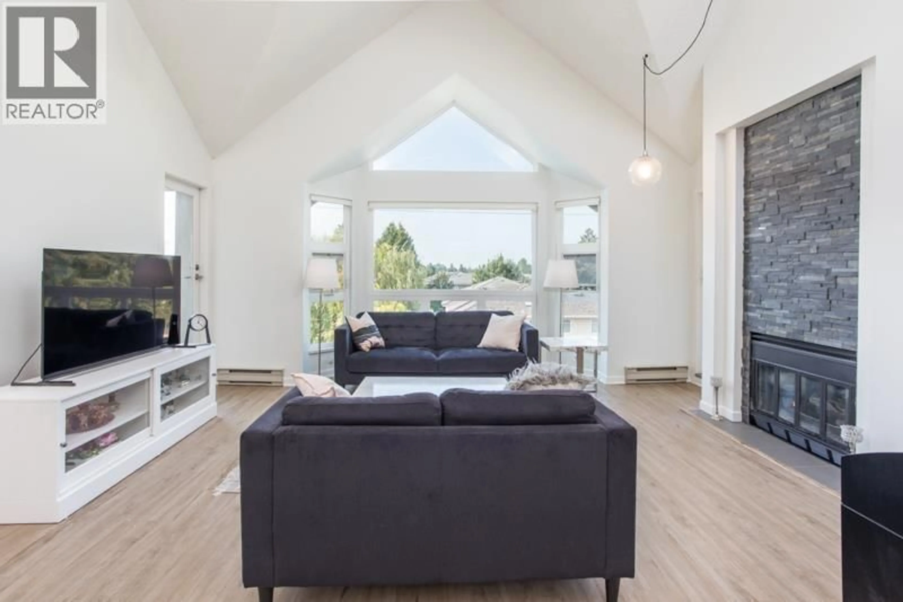 Living room with furniture, wood/laminate floor for 307 - 7200 GILBERT ROAD, Richmond British Columbia V7C3W2