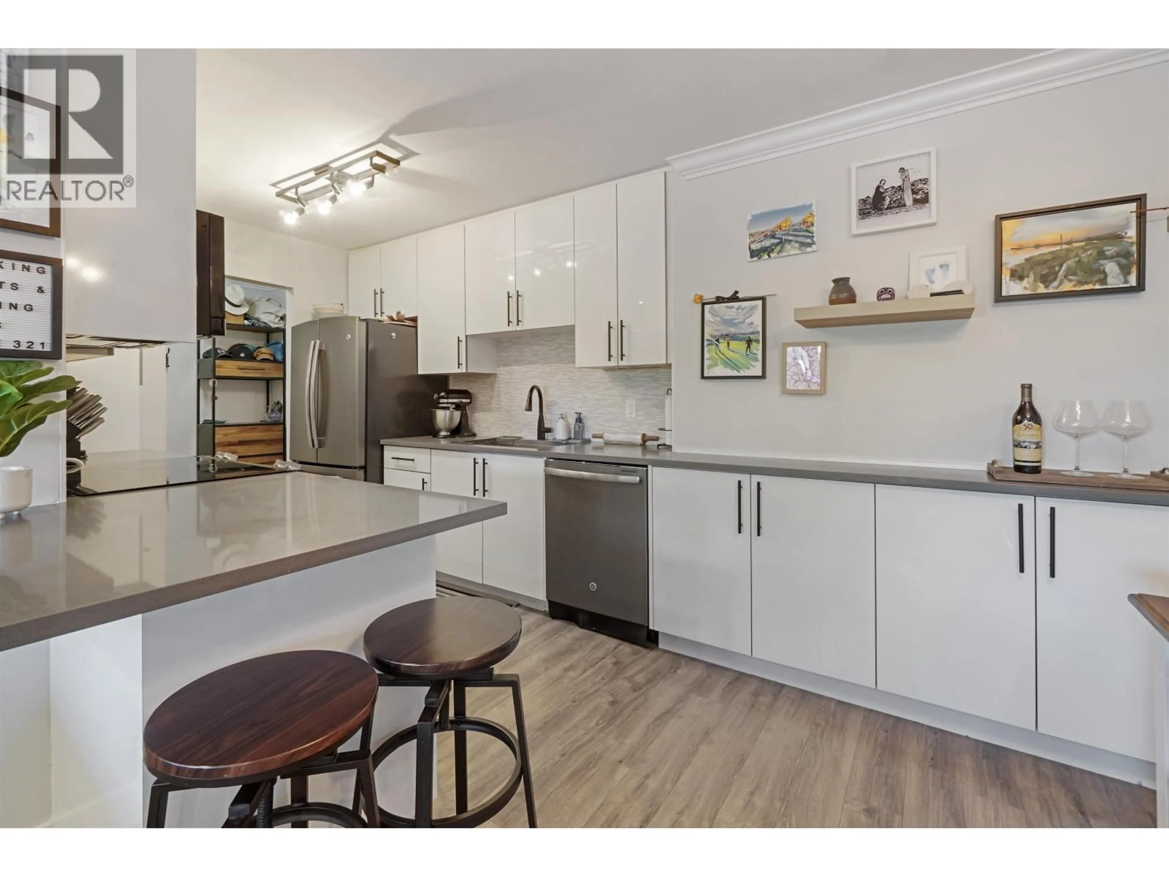 Open concept kitchen, wood/laminate floor for 103 - 8740 NO. 1 ROAD, Richmond British Columbia V7C4L5
