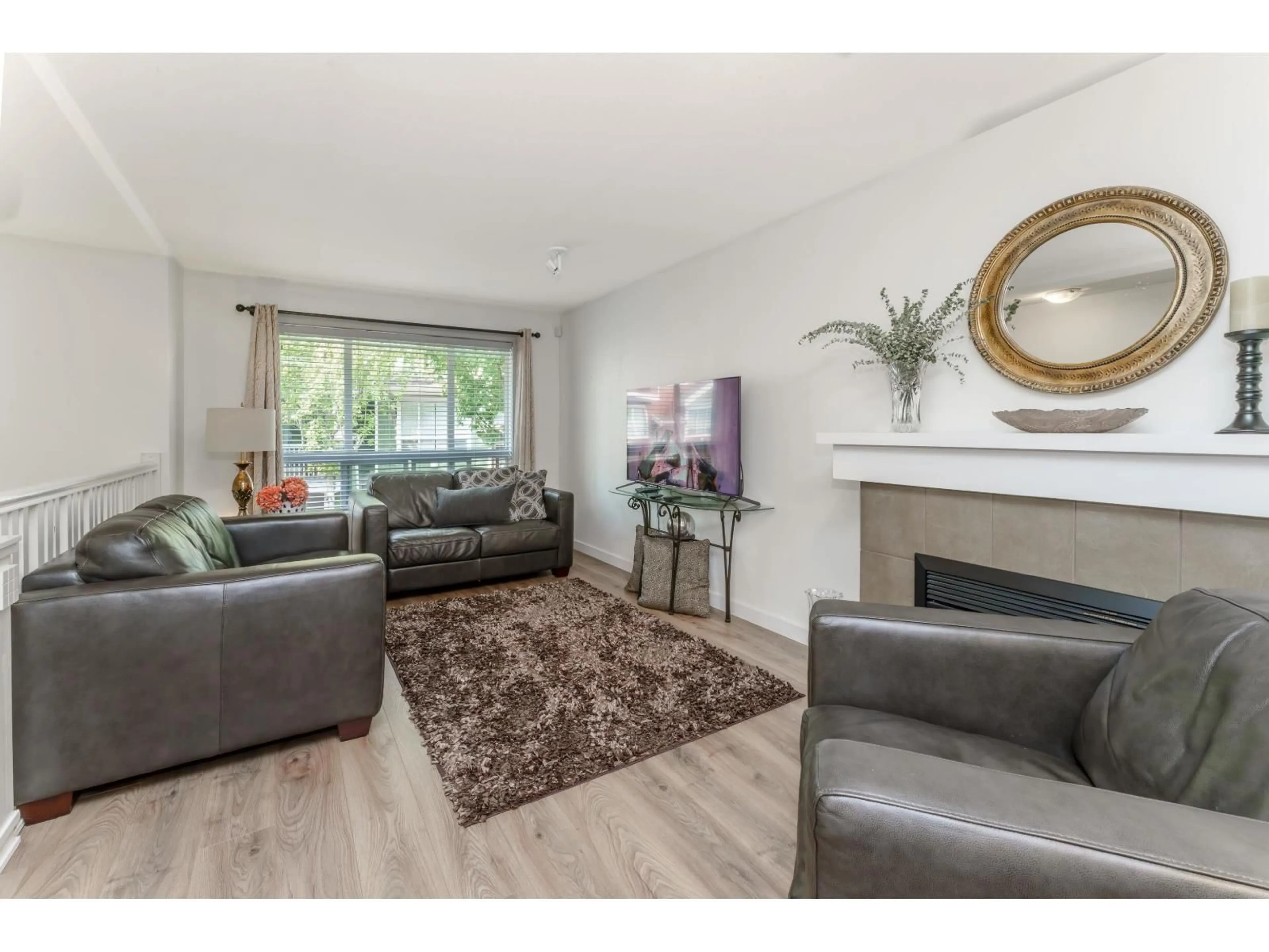 Living room with furniture, wood/laminate floor for 170 - 15168 36, Surrey British Columbia V3Z0Z6