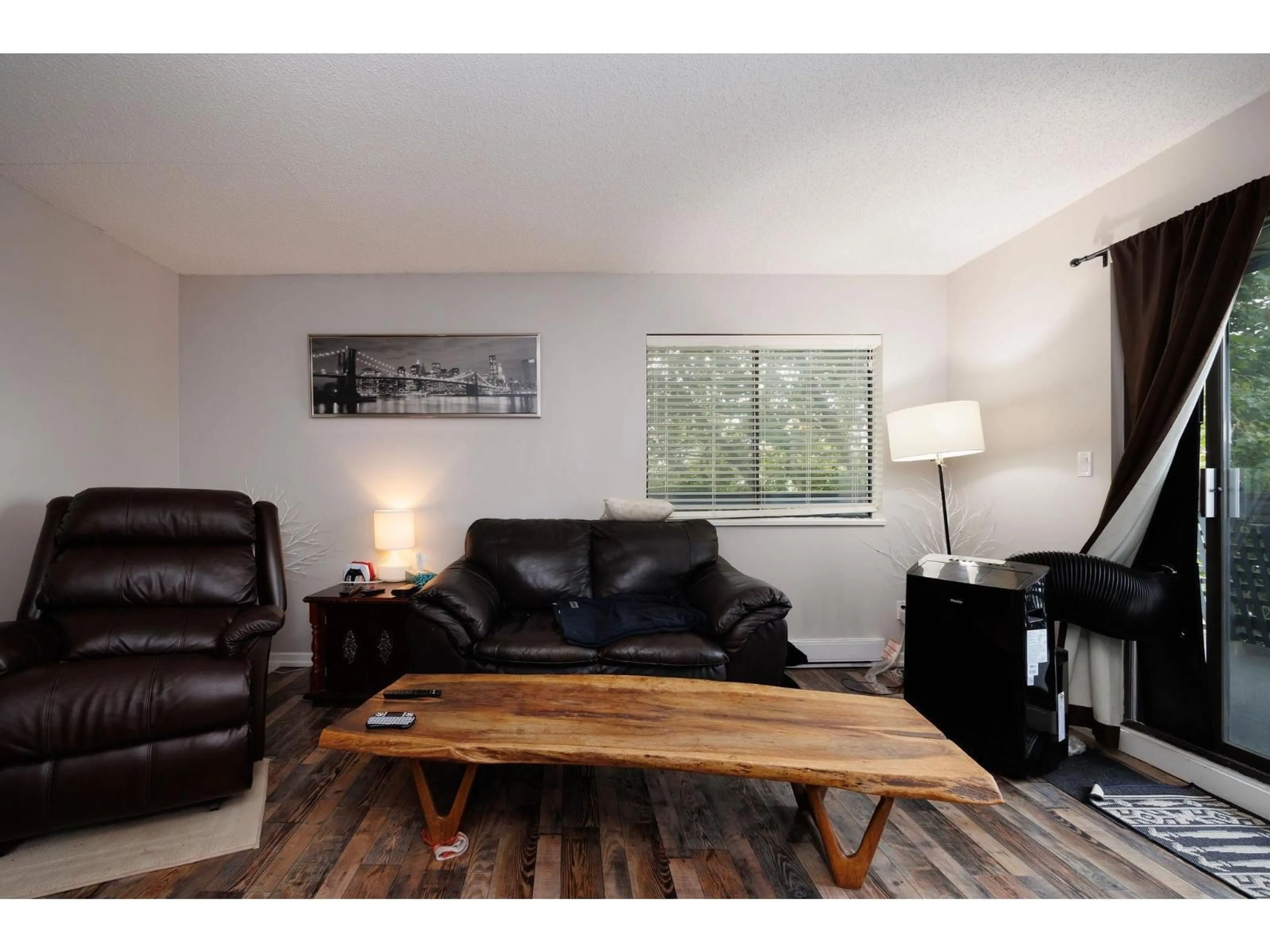 Living room with furniture, wood/laminate floor for 207 - 17661 58A, Surrey British Columbia V3S1N4