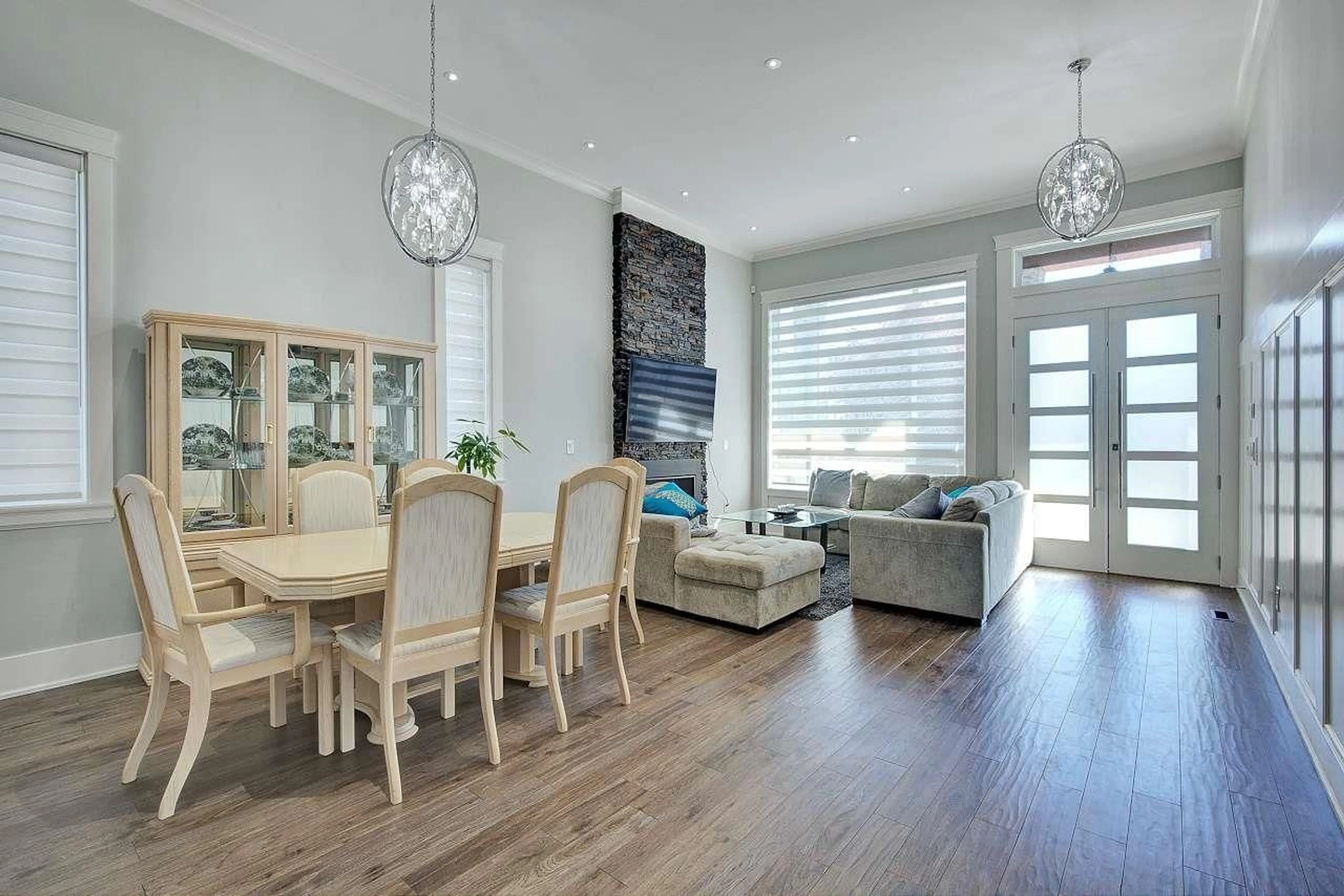Living room with furniture, wood/laminate floor for 7715 154A, Surrey British Columbia V3S1C2