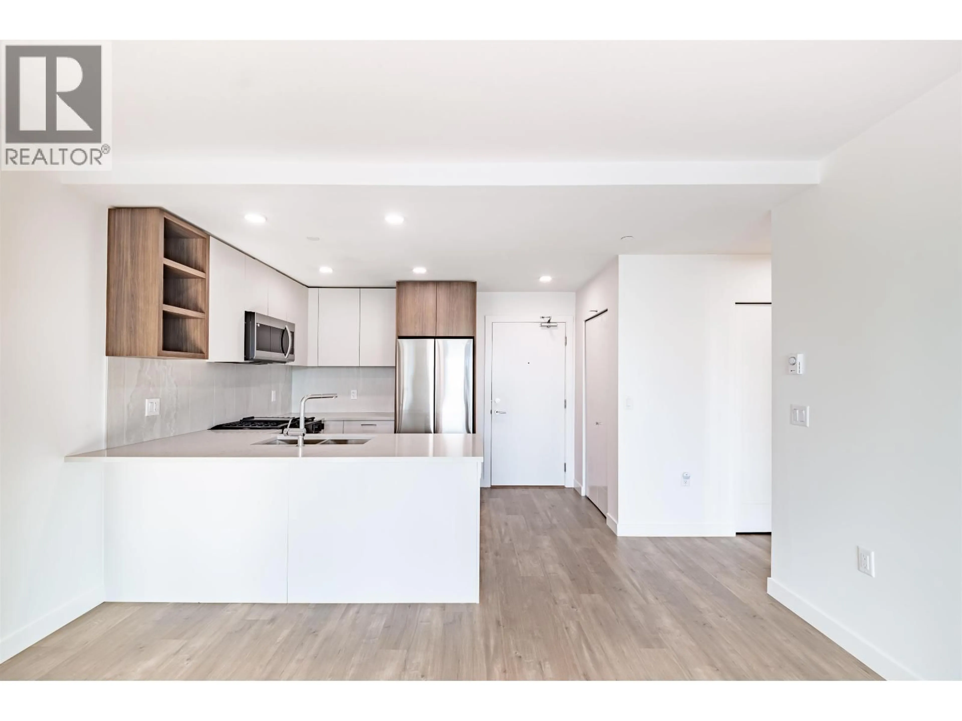 Open concept kitchen, wood/laminate floor for 204 - 723 GROVER AVENUE, Coquitlam British Columbia V3J0L9