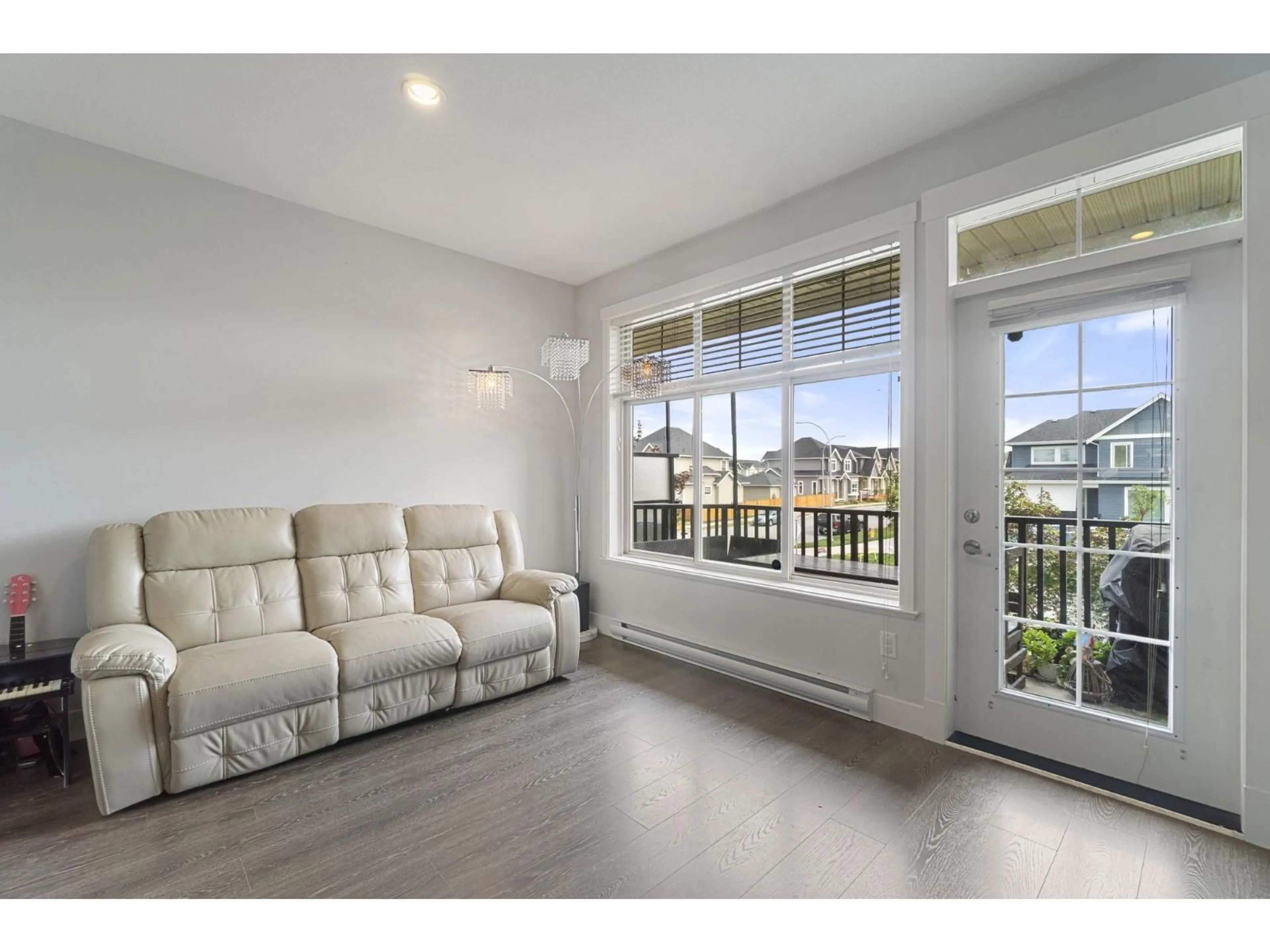 Living room with furniture, wood/laminate floor for 104 - 19525 73, Surrey British Columbia V4N6L7